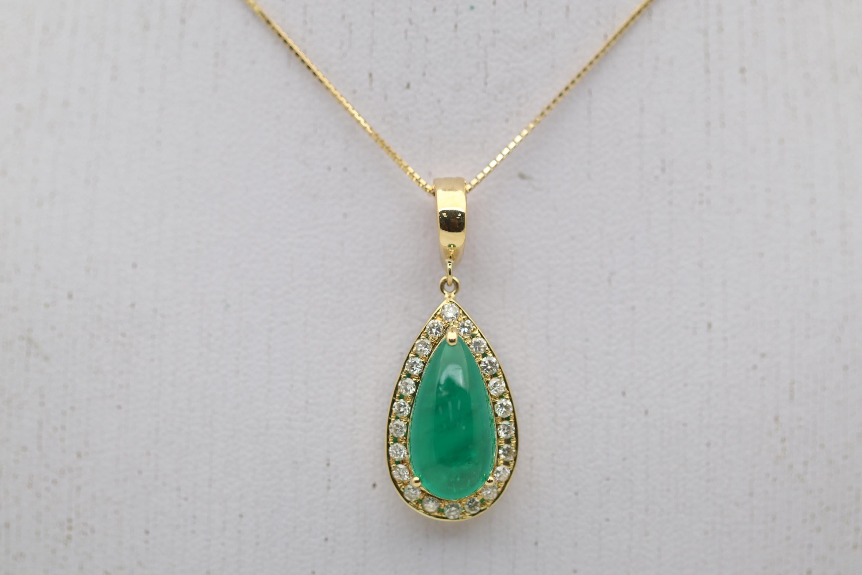 A lovely gold pendant featuring a 5.04 carat emerald. The emerald has a rich deep green color and is shaped into a drop-shaped cabochon. It is complemented by 0.44 carats of round brilliant-cut diamonds set around the emerald and add brilliance and