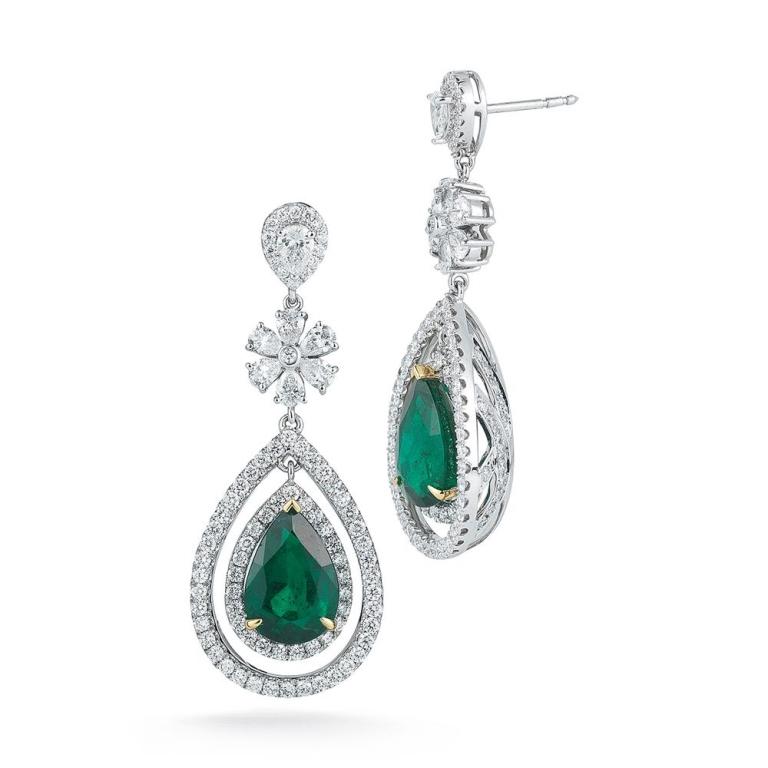 EMERALD DROP EARRING An elegant and dynamic pair of earrings showcased in this elegant fancy design where 2 twin certified Emeralds each being roughly 5 cts each sit Item: # 01825 Metal: 18k W / Y Lab: Gia Color Weight: 10.47 ct. Diamond Weight: