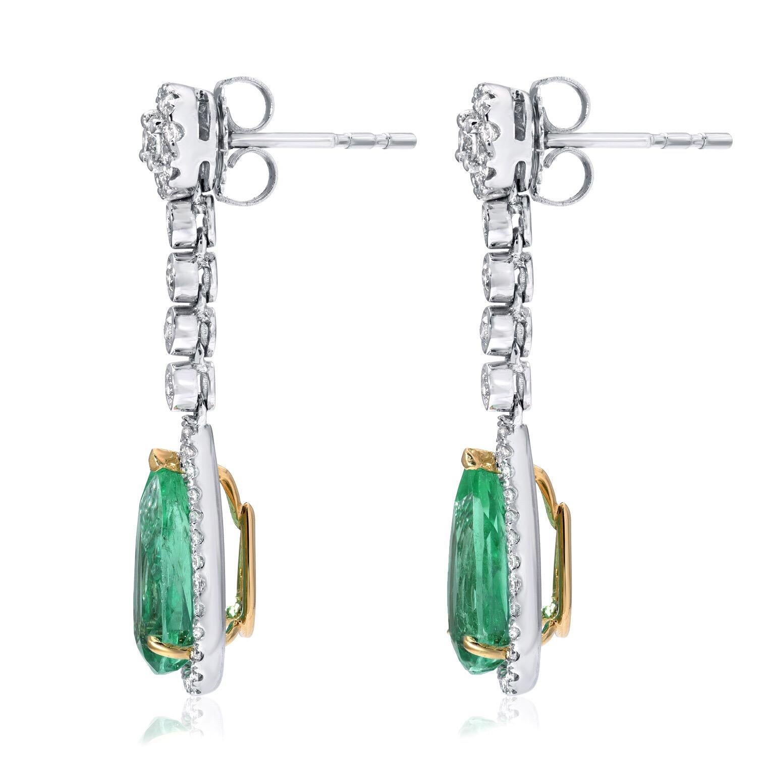 Colombian Emerald earrings featuring a pair of 4.61 carats total pear shape Emeralds, adorned by a total of 0.92 carats of round brilliant diamonds. These drop Emerald earrings are crafted in 18K white gold and 18K yellow gold.
Total length: Approx.