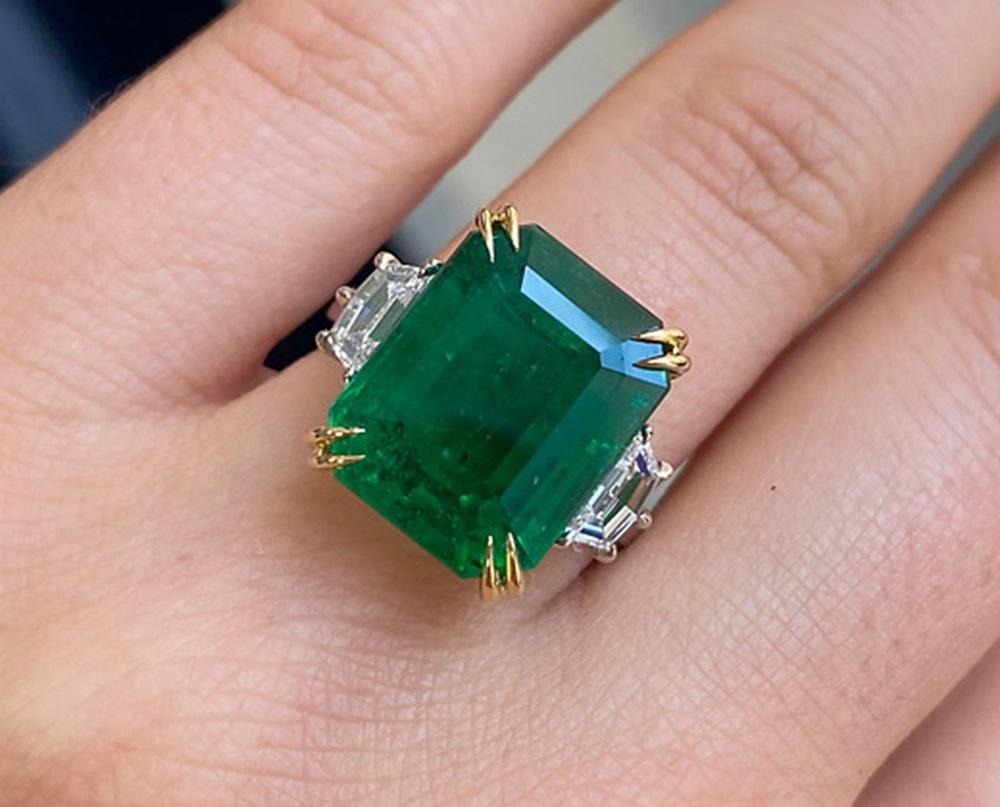 Emerald Weight: 10.02 CT, Diamond Weight: 1.01 CT, Metal: Platinum/18K Yellow Gold, Ring Size: 7, Shape: Emeraldcut, Color: Green, Hardness: 7.5-8, Birthstone: May