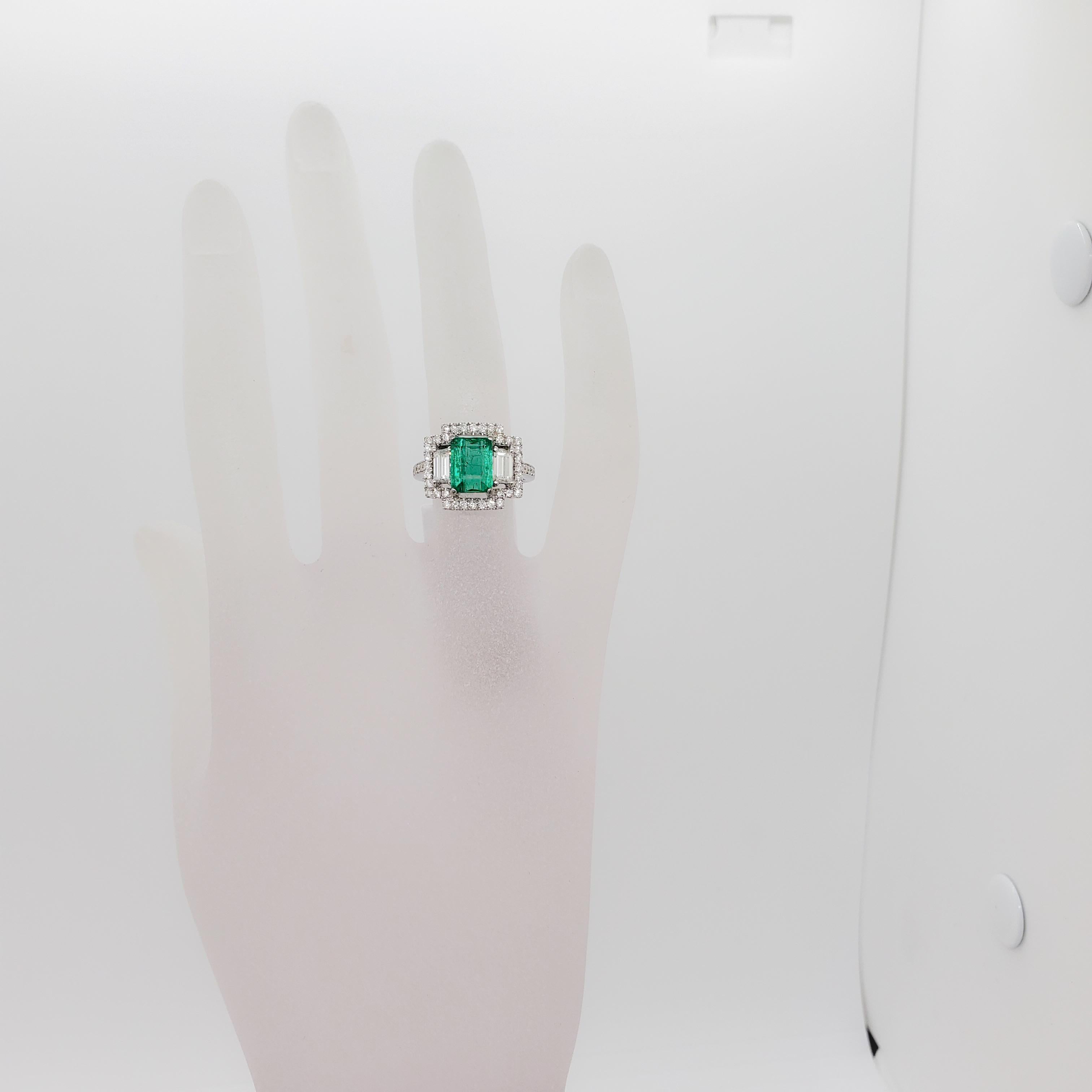 Beautiful bright green emerald emerald cut weighing 2.05 ct. with 1.14 ct. of good quality white diamond rounds. Handmade 18k white gold mounting in size 6. Well made and easy to wear daily or for a special occasion.