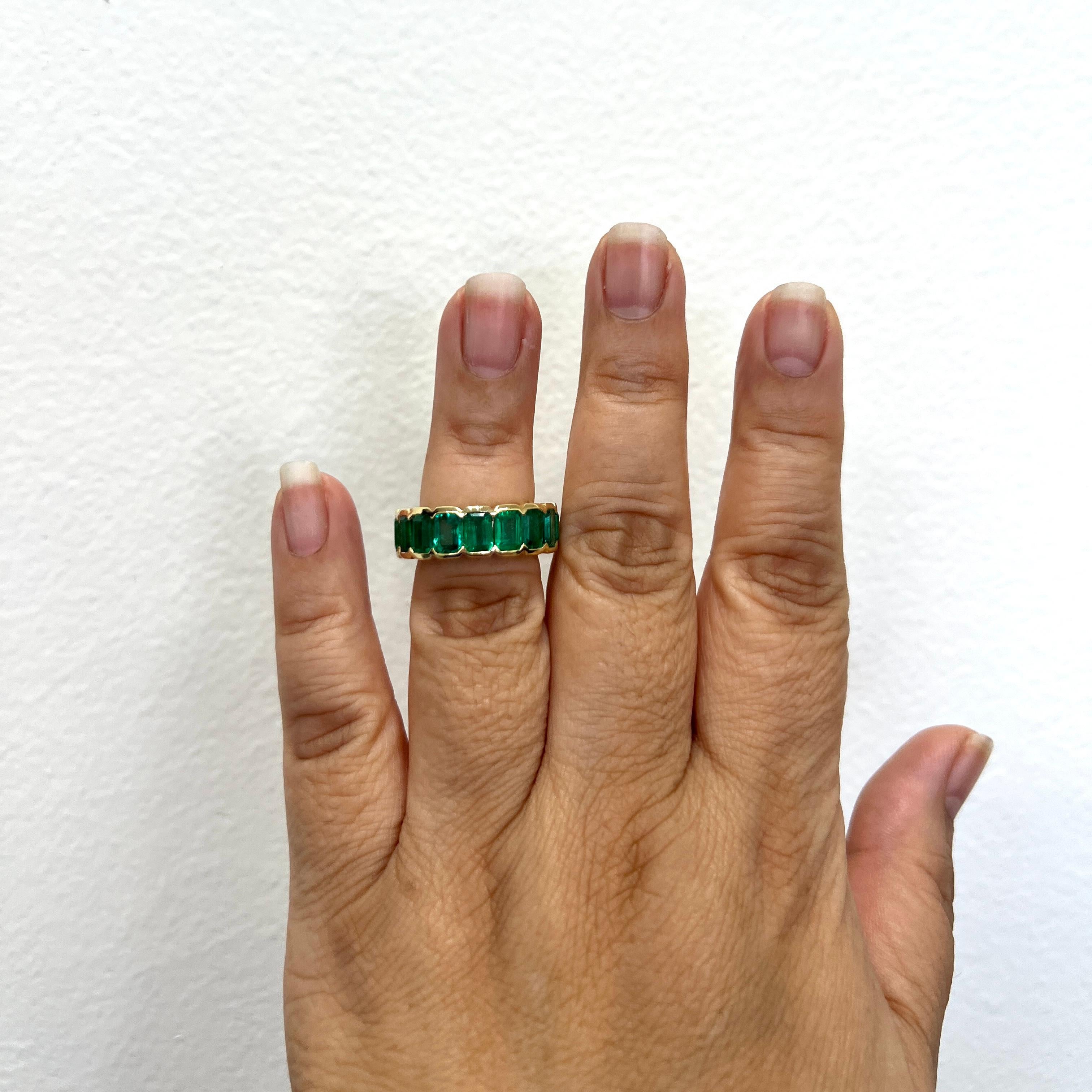 Stunning 9.80 ct. bright green emerald emerald cuts.  Total of 17 stones.  Handmade in 18k yellow gold.  Ring size 6.5.
