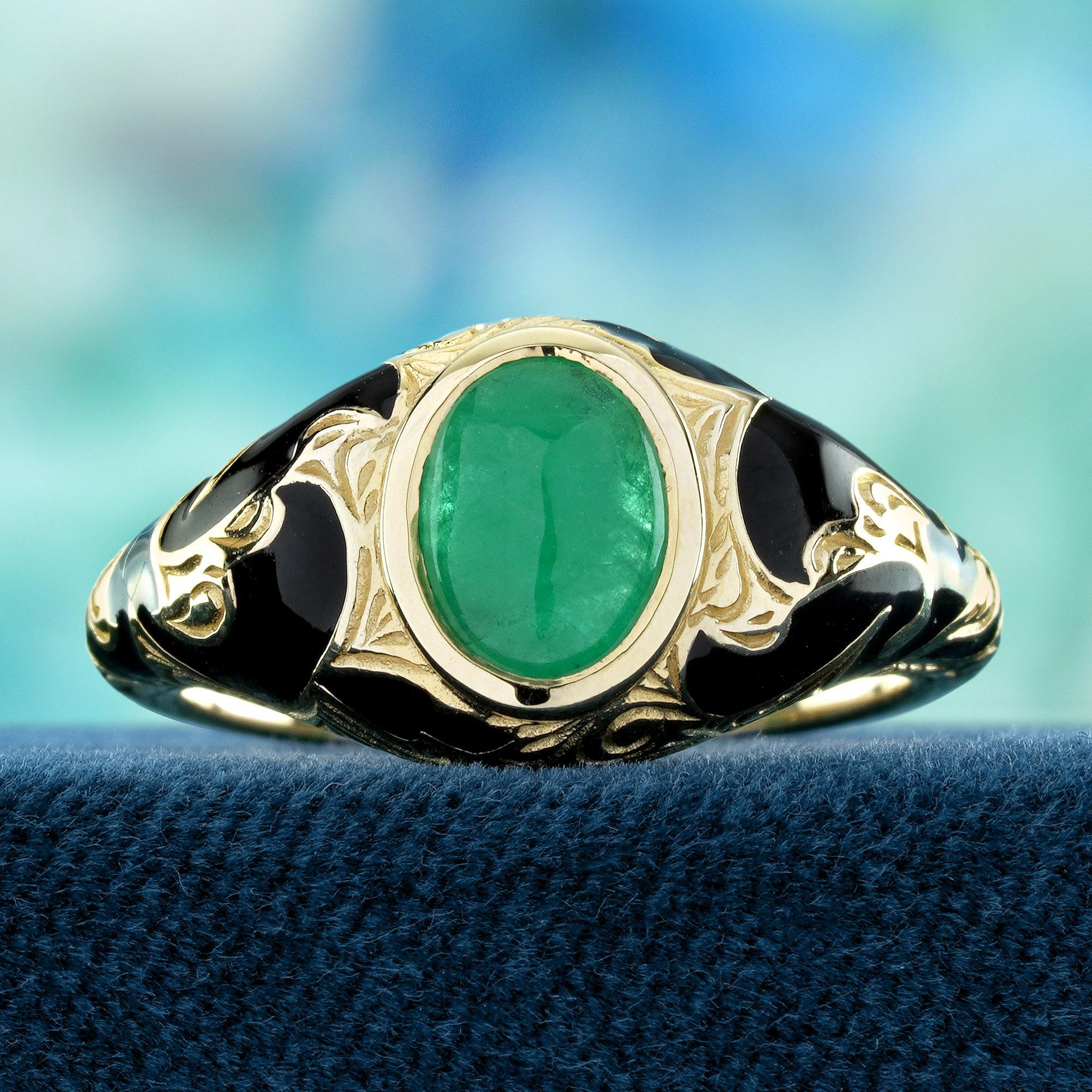 A lush cabochon emerald sits proudly at the center, drawing the eye with its rich, natural glow. The shoulders of the ring are adorned with a delicate floral motif in vibrant enamel, capturing vintage elegance with artistic flair. The bold contrast