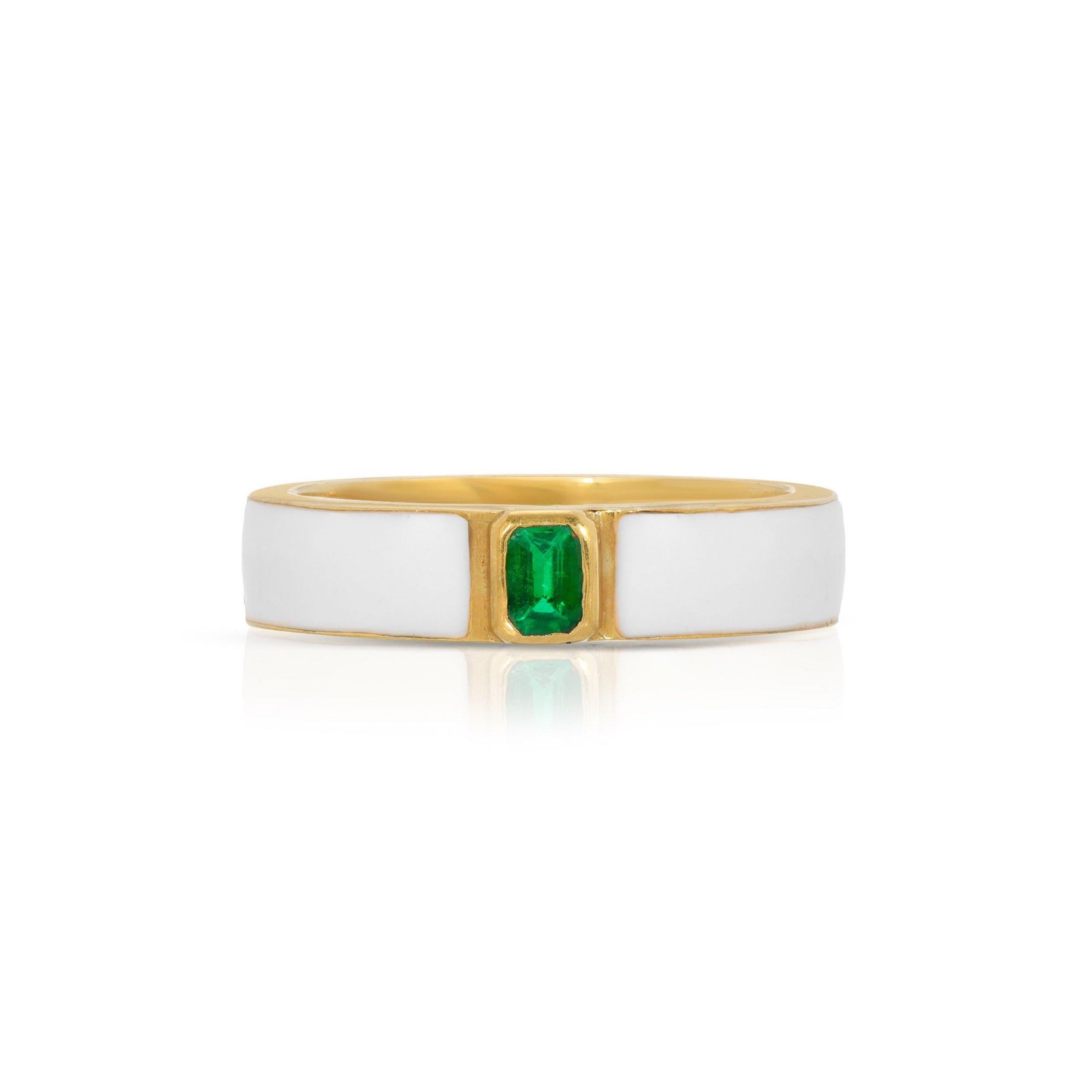 A beautiful band ring of modern design with an Emerald Cut Emerald and enamel. This ring features glossy white enamel contrasted by a fiery Emerald.  This ring has 22 Karat Gold overlay Silver accents and a 22 Karat Gold overlay Silver interior.