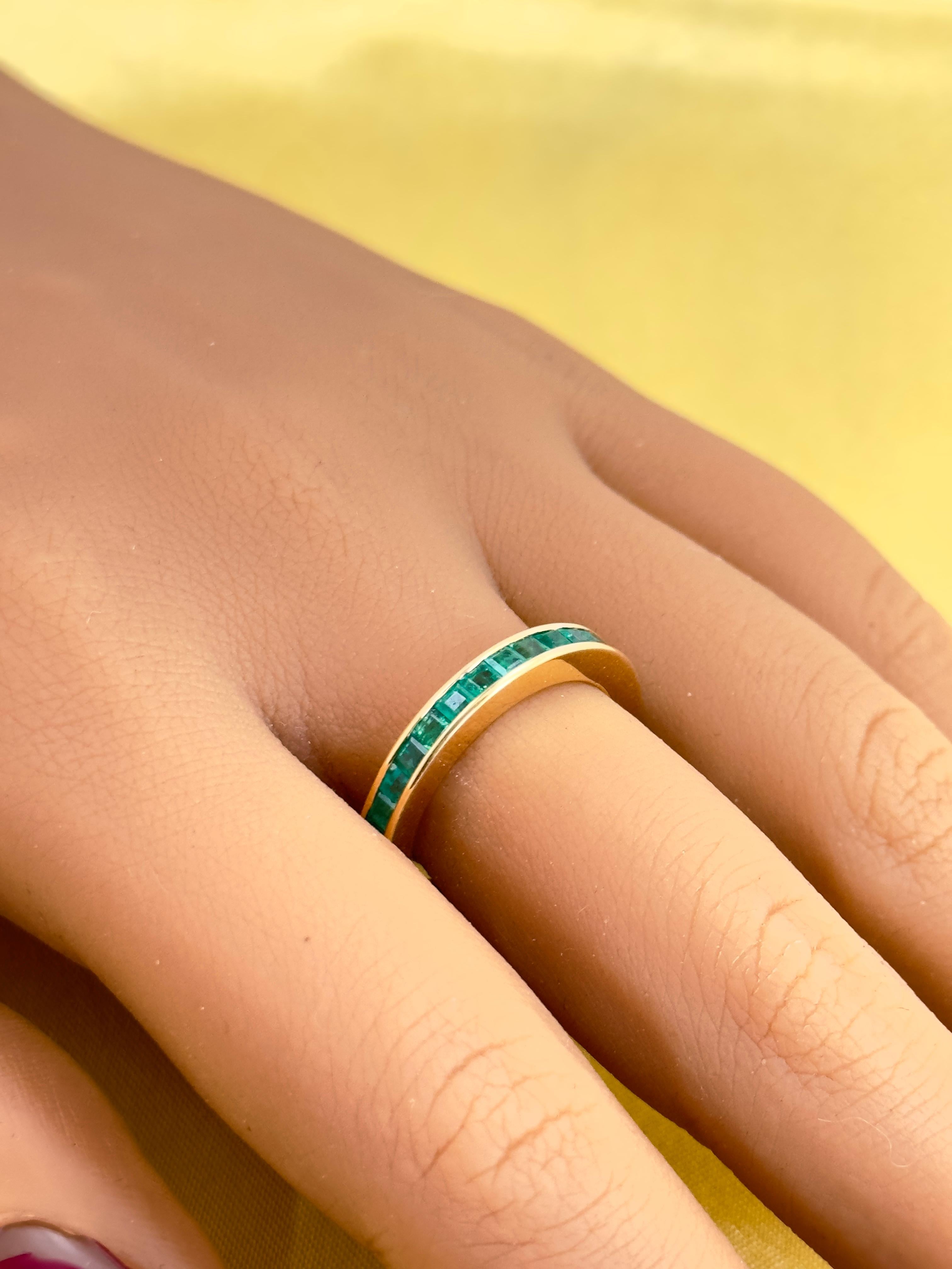 Princess cut Emeralds set in 18k yellow gold! A beautiful channel setting holds these natural emeralds securely in place in solid 18k yellow gold. The band is very smooth on the inside so it is comfortable to wear and the emeralds have great luster