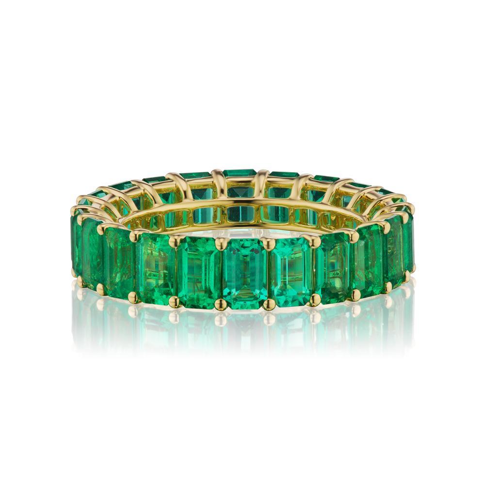 EVERGREEN EMERALD ETERNITY BAND BY TAKAT
A timeless eternity Emerald band in 18k Yellow Gold with emerald-cut stones around. This design is one for the classics. ( Ring Size 6.5 )
Item:	# 03794
Setting:	18K Y
Color Weight:	5.75 ct. of Emerald