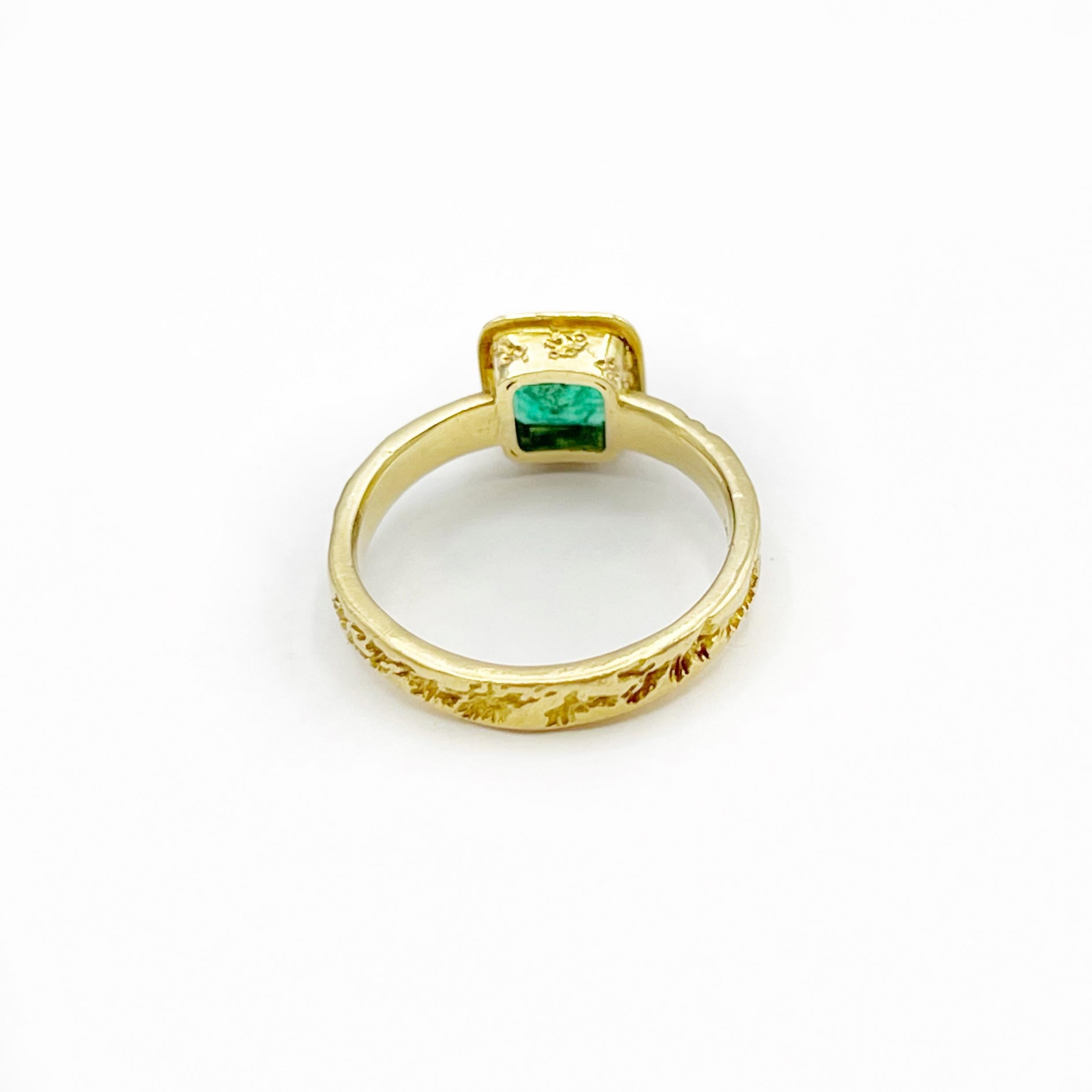 This beautiful emerald cut emerald is 1.10 carats set in heavy 18 karat gold. The design is classic and Old World with a touch of filigree. The ring is a size 6 1/2 and can be sized. You can wear it alone or stack with other rings and it would also