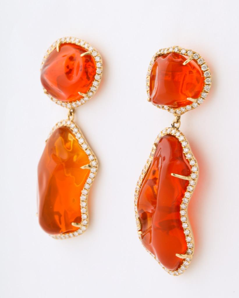 Four baroque shape fire opals (37cts) are matched for size and shape to create this magnificent one of a kind pair of earrings.  Each stone is delicately framed in white diamonds (1ct).  Bold and bright with a strong jolt of color, these earrings