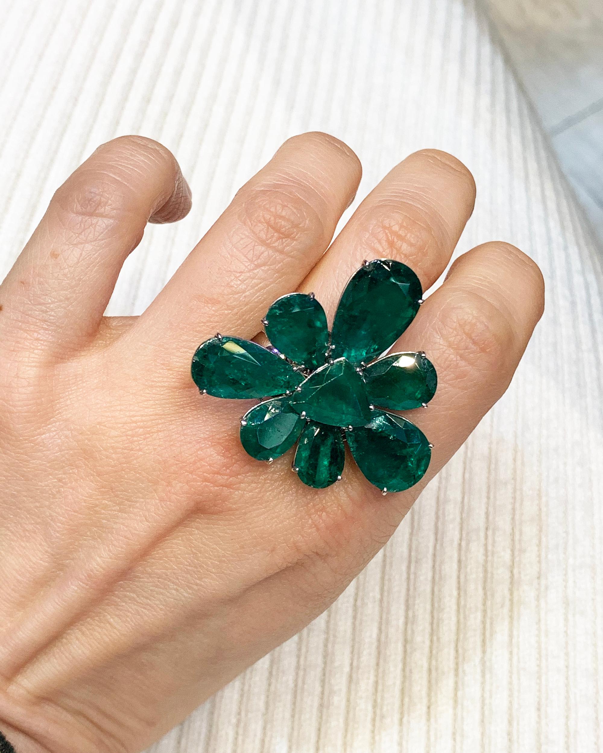 This Spectra Fine Jewelry Colombian Emerald Convertible Flower Ring and Pendant, made in the Contemporary Era, circa 2010s, features 8 emeralds including 7 pear-shape and 1 triangular, weighing approximately 27.09 carats total. The 7 pear shape