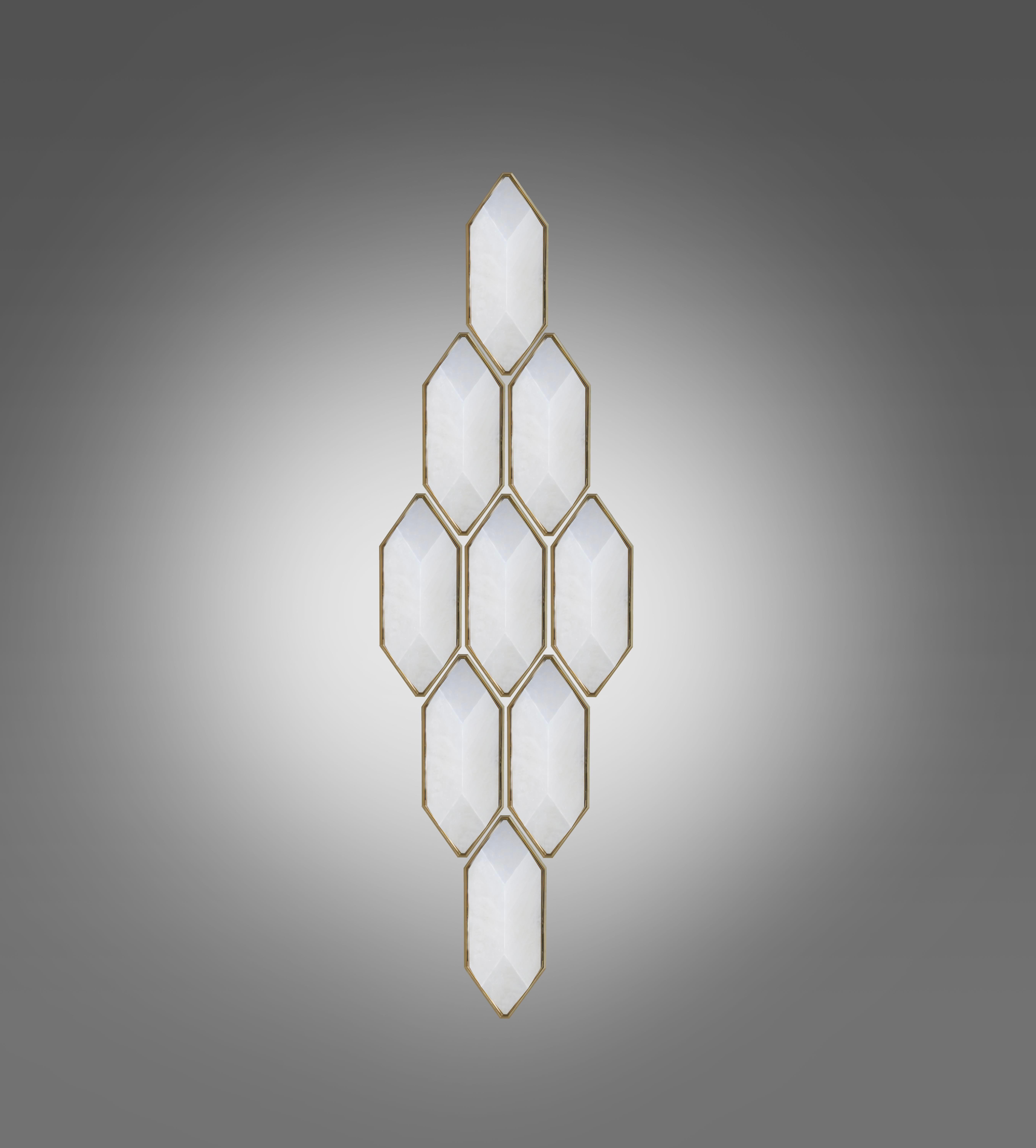 Group of emerald form, fine carved rock crystal sconces set up in a diamond form. Created by Phoenix gallery NYC. 
Each sconce is 12” high, 5.5” wide, and 4.5” projection, with polished brass frame. 

Custom size upon request.