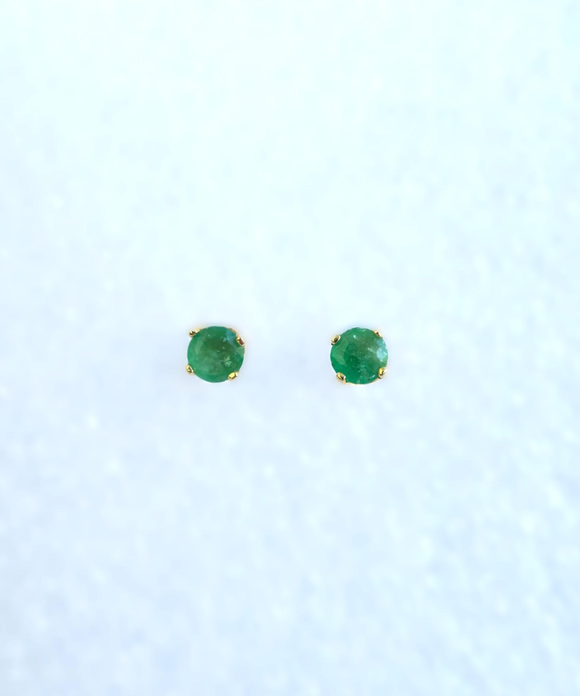 A vintage pair of Emerald gemstone and 14 karat yellow gold stud earrings, circa mid to late-20th century. Emeralds are a beautiful green hue measuring approximately .25 carat each, totaling .5 carat. Wear in first or second holes, up ear, etc. A