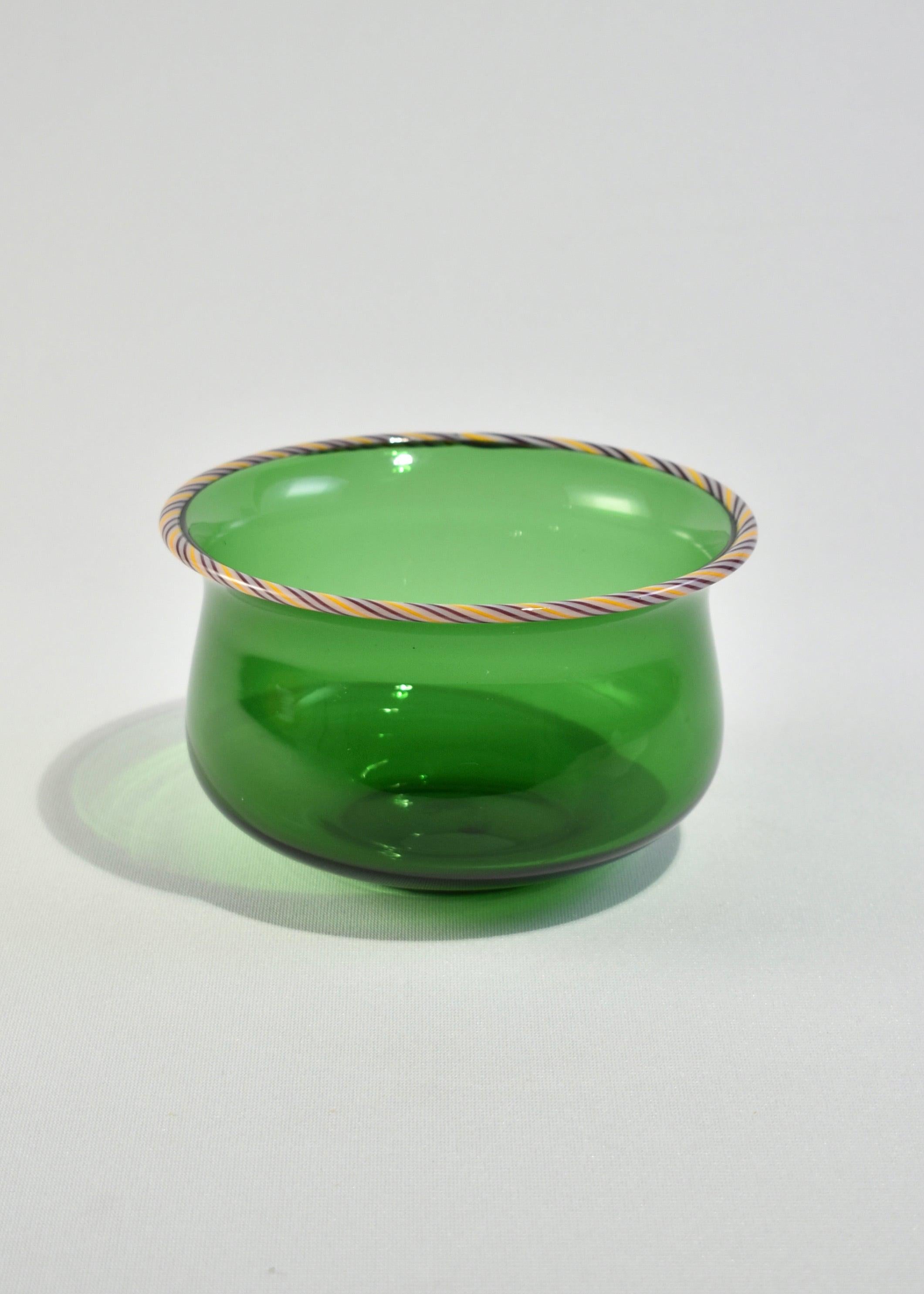 Vintage blown glass bowl in a beautiful green color with purple and yellow twisted cane trim.