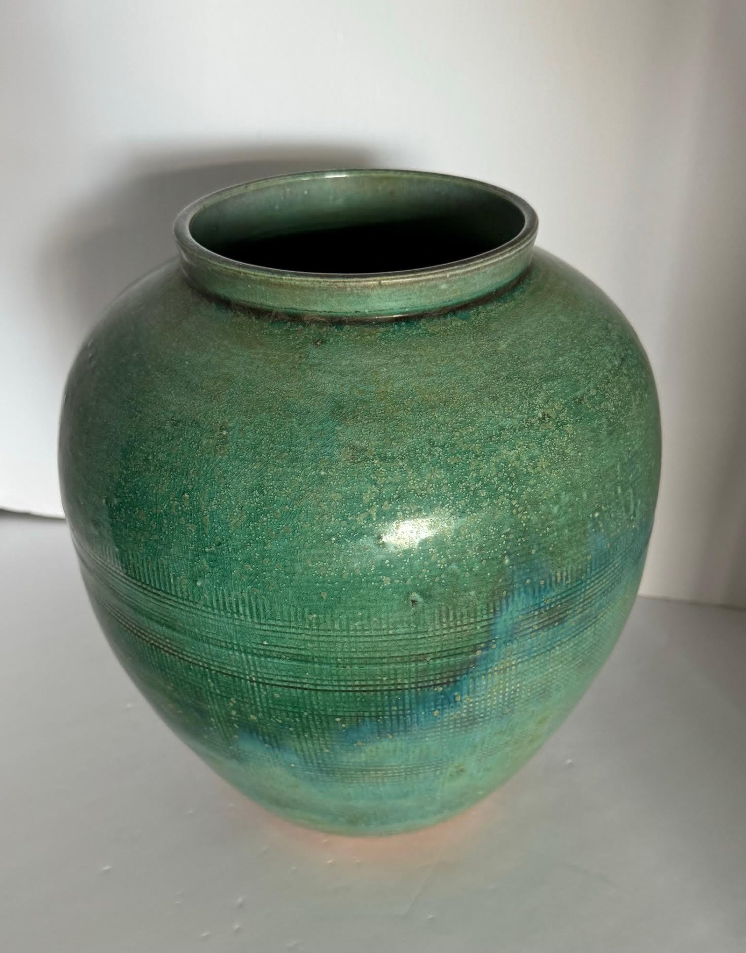 Contemporary Chinese emerald glazed squatted shape vase.
Criss cross etched design at base.
Part of a collection