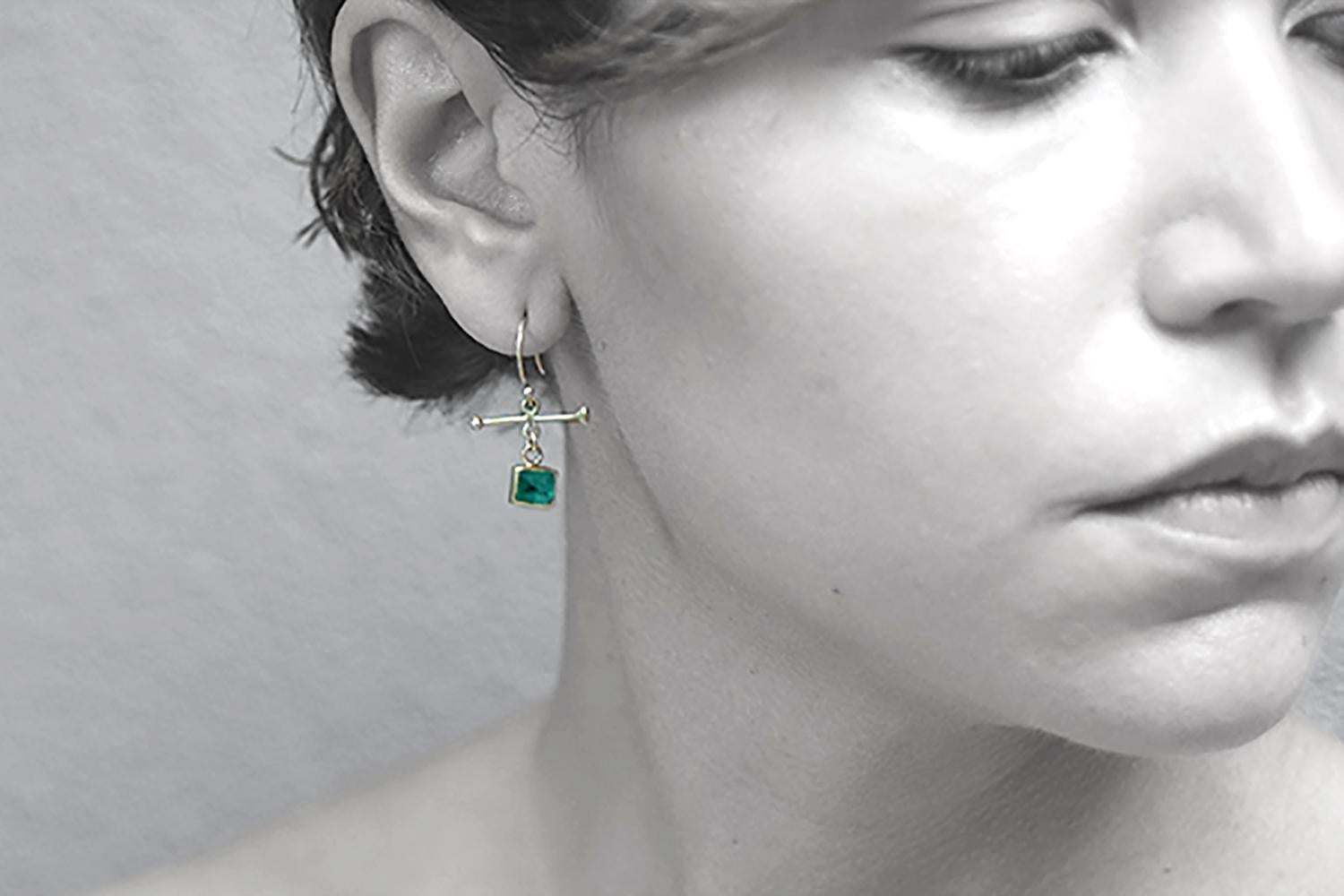 These dainty earrings feature 2 emeralds (1.95 carats) bezel set in 18K gold.  They dangle from my 18K crossbar inspired by Victorian watch fobs. These earrings are one of a kind and measure 1