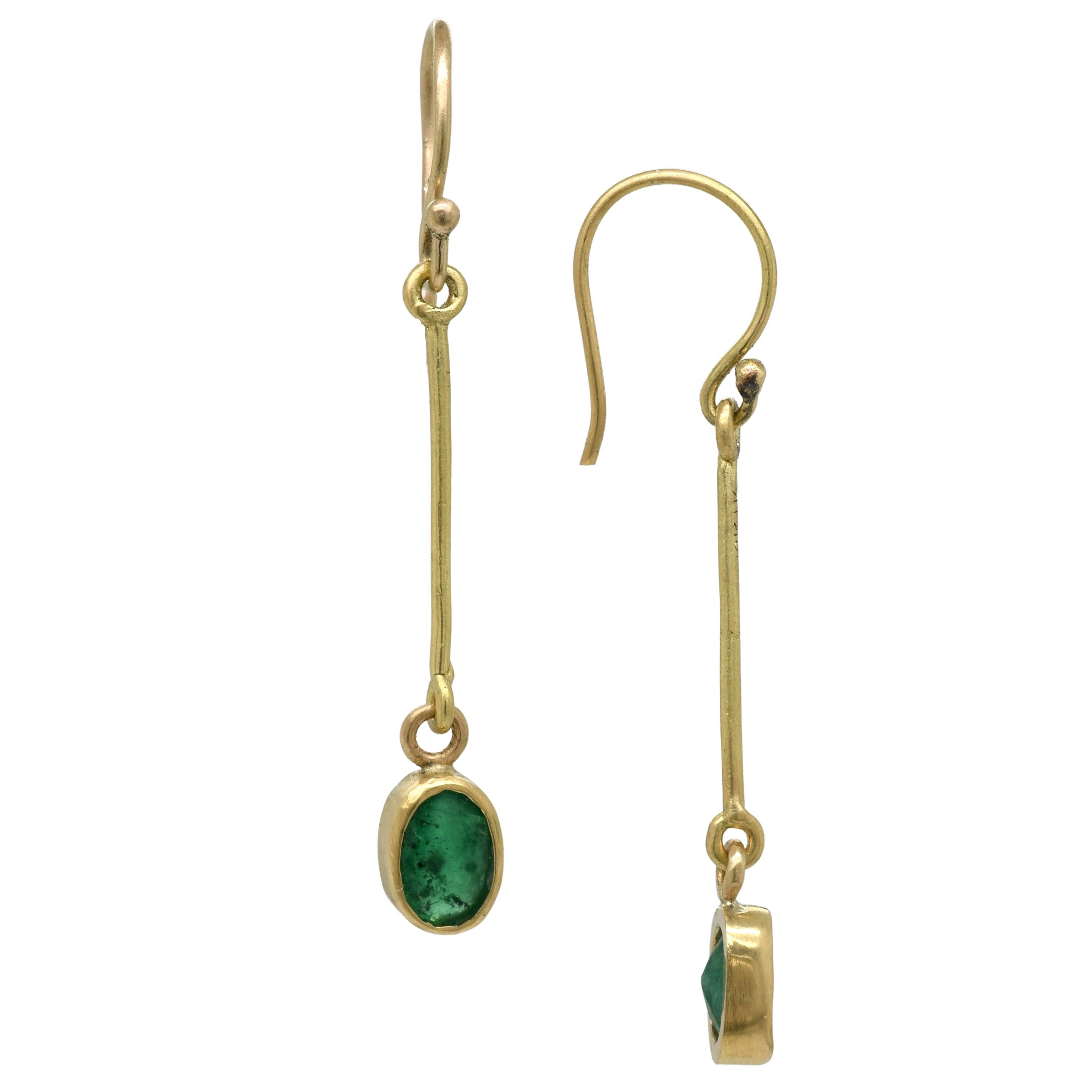 Inspired by art deco design, these 18k gold earrings feature delightfully faceted emerald ovals.
Measures: 1.75