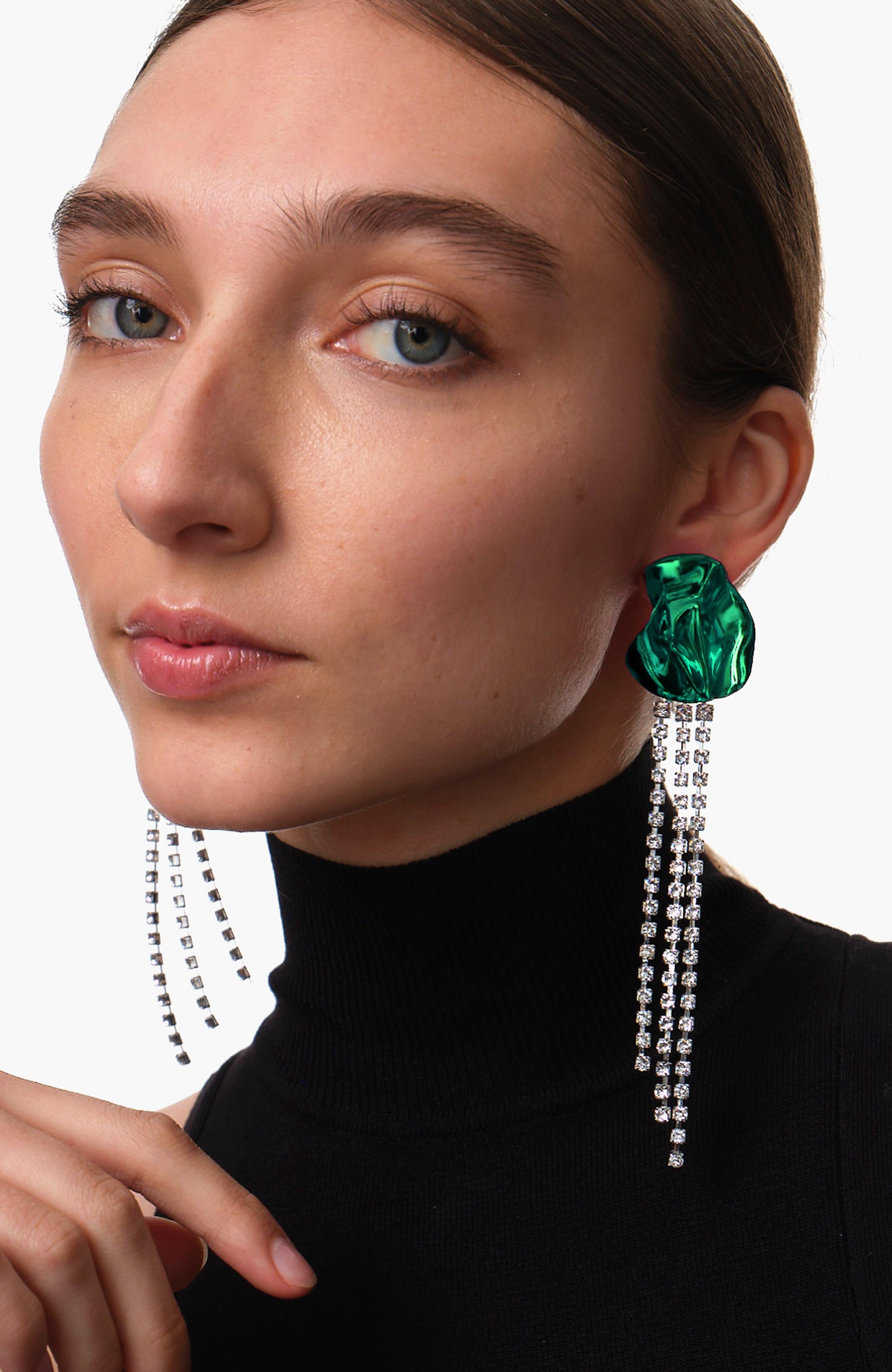The Georgia crystal-embellished earrings from Sterling King feature a sculptural shape embellished with cascading clear crystals. Inspired by the works of Georgia O'Keeffe, these floral-inspired earrings are finished with vibrant green ceramic