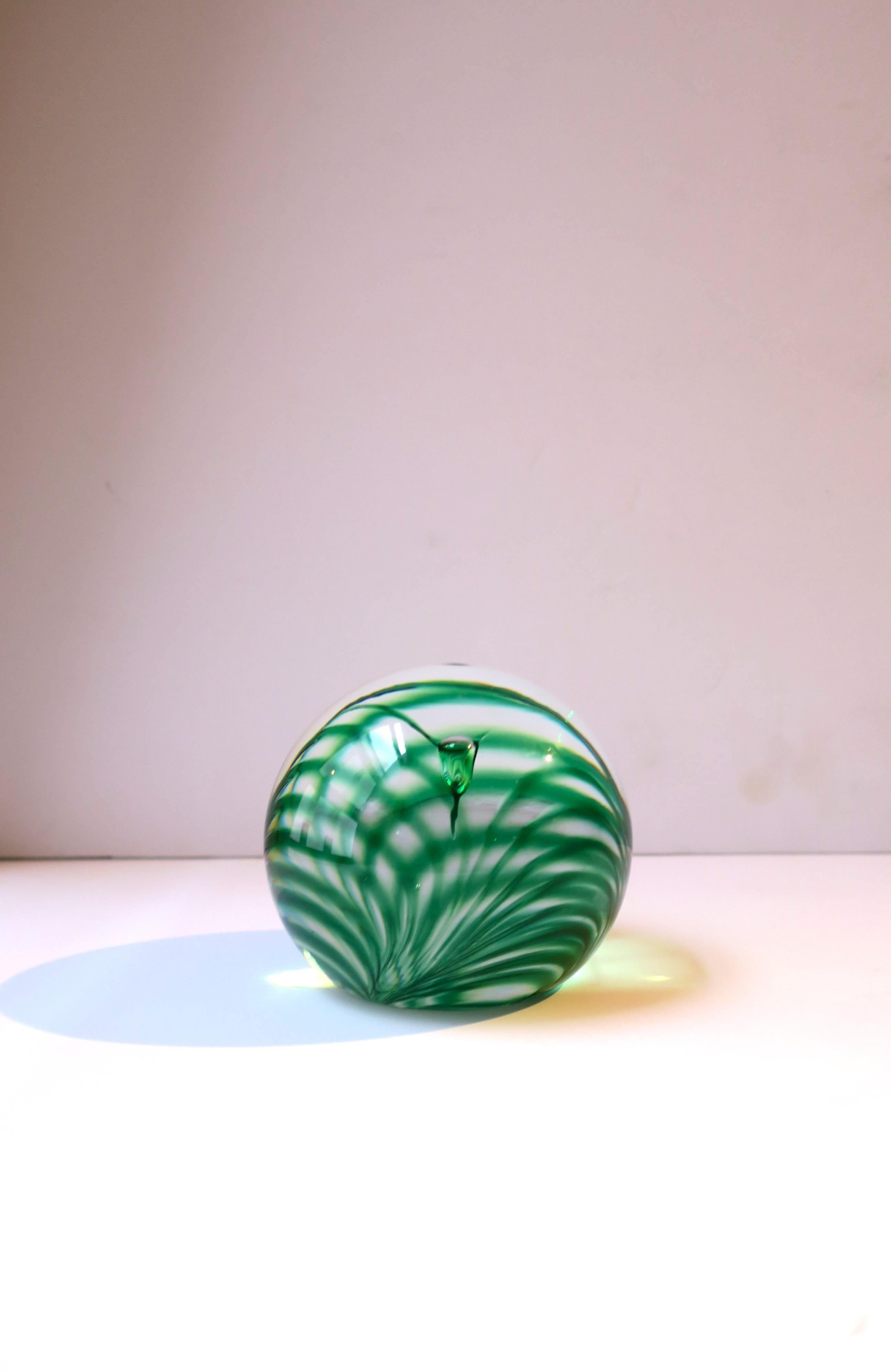 A beautiful Emerald green art glass ball sphere, in the modern style, with a tropical grass or palm-like design, circa late-20th century. Piece is a nice size, a little bigger than the typical size, measuring 3.5