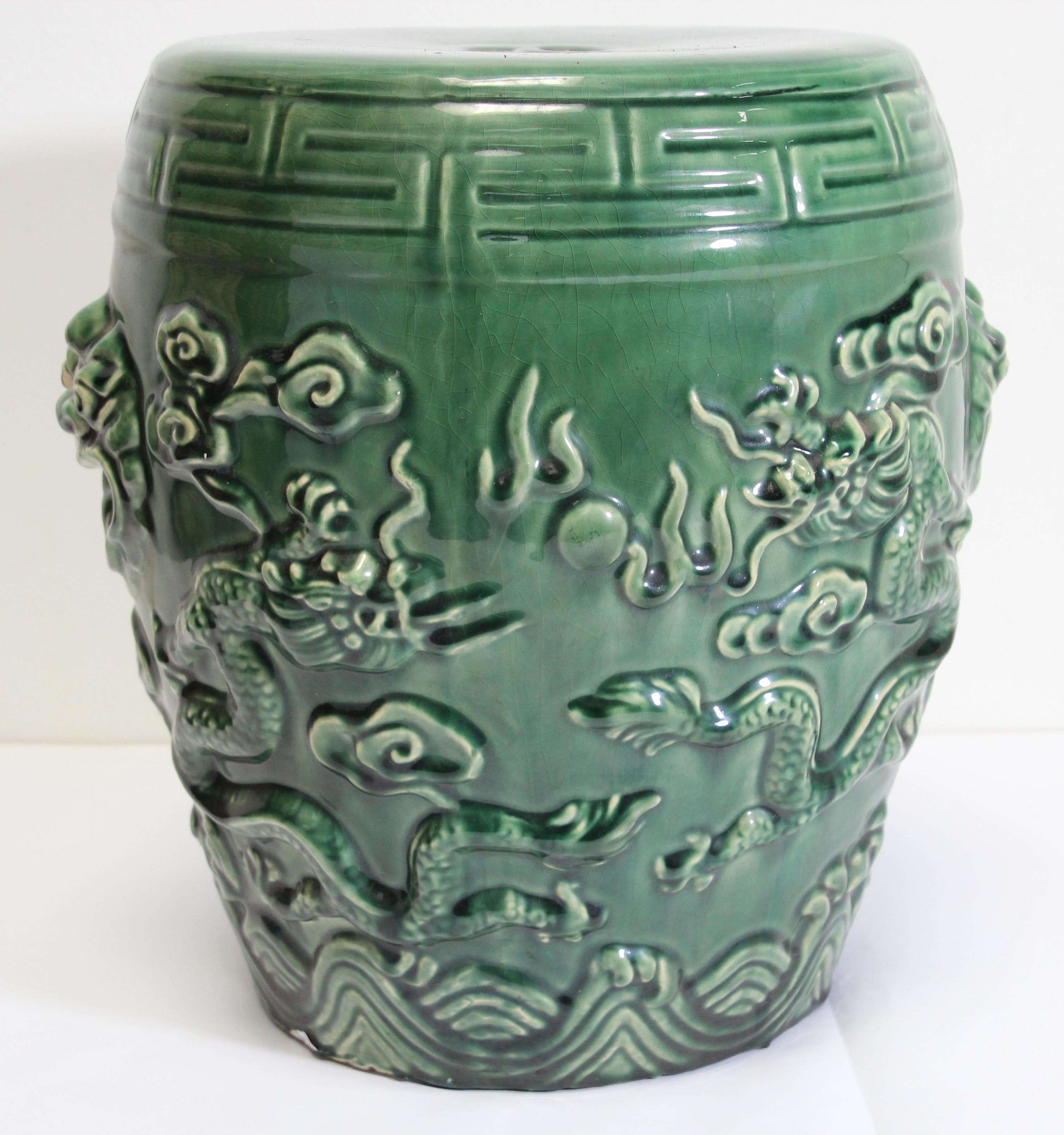 Emerald green Chinese ceramic garden stool.
Nicely carved on each sides with foliages and dragons.
Fen Shui designs with water, dragons and foliages
Great to use indoor or outdoor as a stool, end table, or plant stand.
Light, easy to carry