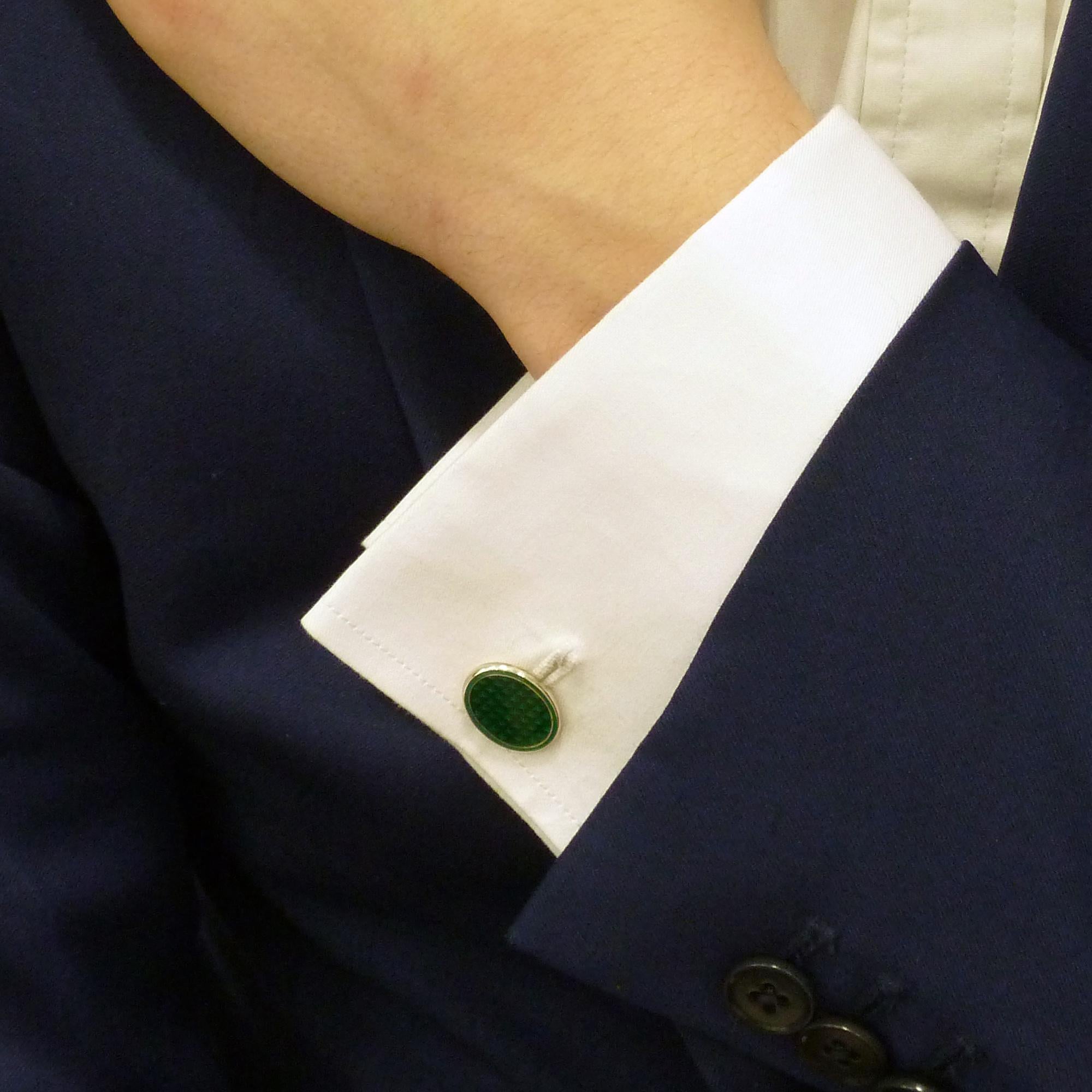 A beautiful pair of enamel oval cufflinks in sterling silver. 

Each cufflink is designed as two oval sterling silver plaques, both decorated with reflector green enamel. 

The plaques connected with a link chain making them easier for the wearer to