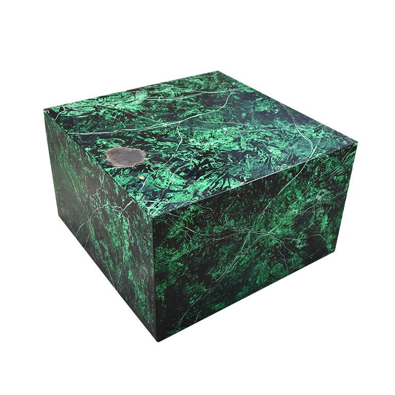 A square wooden coffee table decorated in an emerald green, black and white faux malachite finish. The piece is created from wood and is not extremely heavy. All four sides and the top are covered in a green malachite look veneer. A lovely coffee or