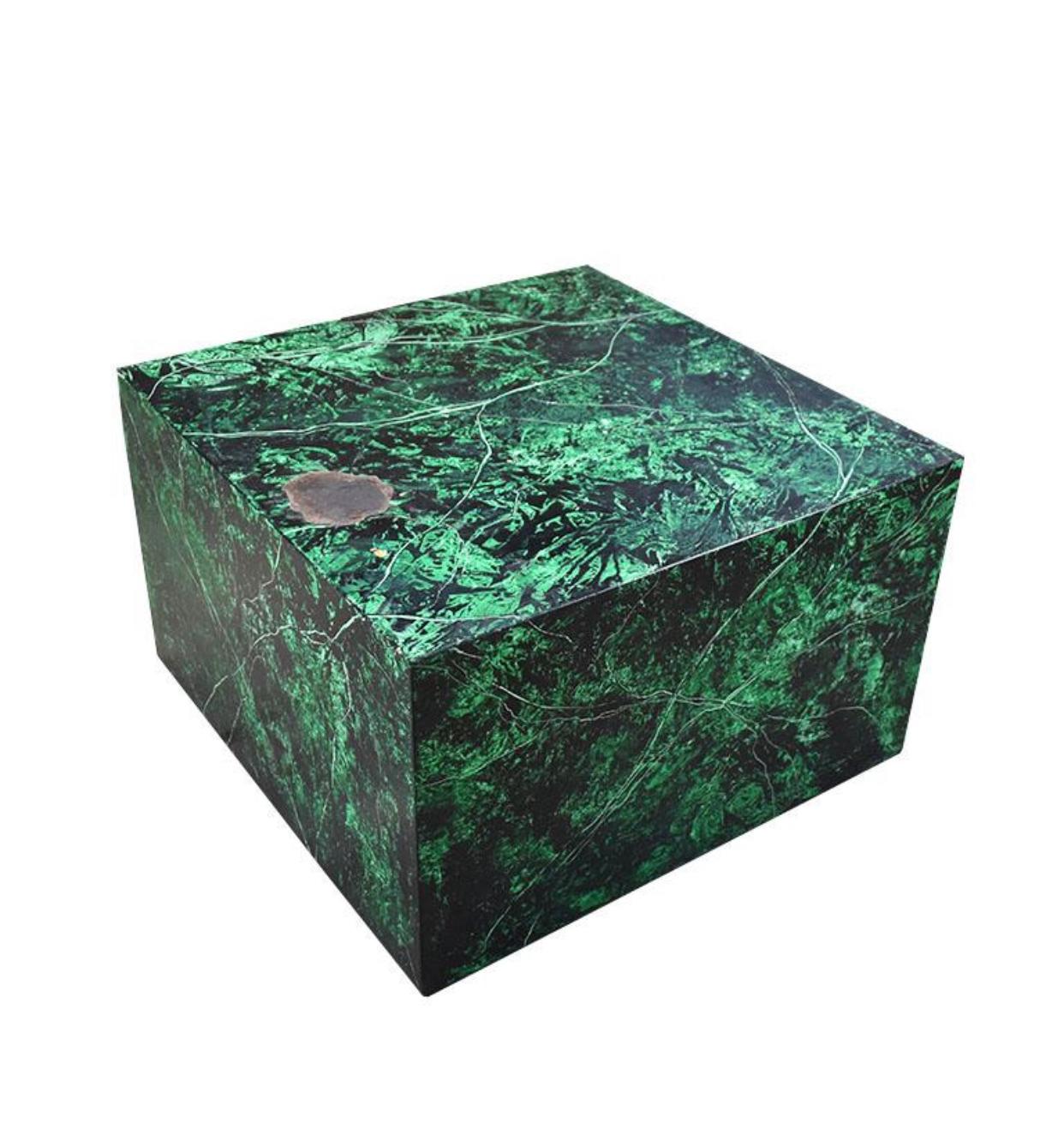 A square wooden coffee table decorated in an emerald green, black and white faux malachite finish. The piece is created from wood and is not extremely heavy. All four sides and the top are covered in a green malachite look veneer. A lovely coffee or