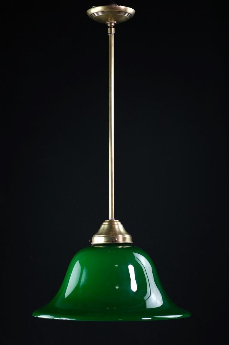 Circa 20th Century German made bell shaped glass shade with a striking emerald color. This pendant light comes complete with a U.S.A. made brass pole fitter and canopy. The price includes cleaning and wiring. Small quantity available at time of