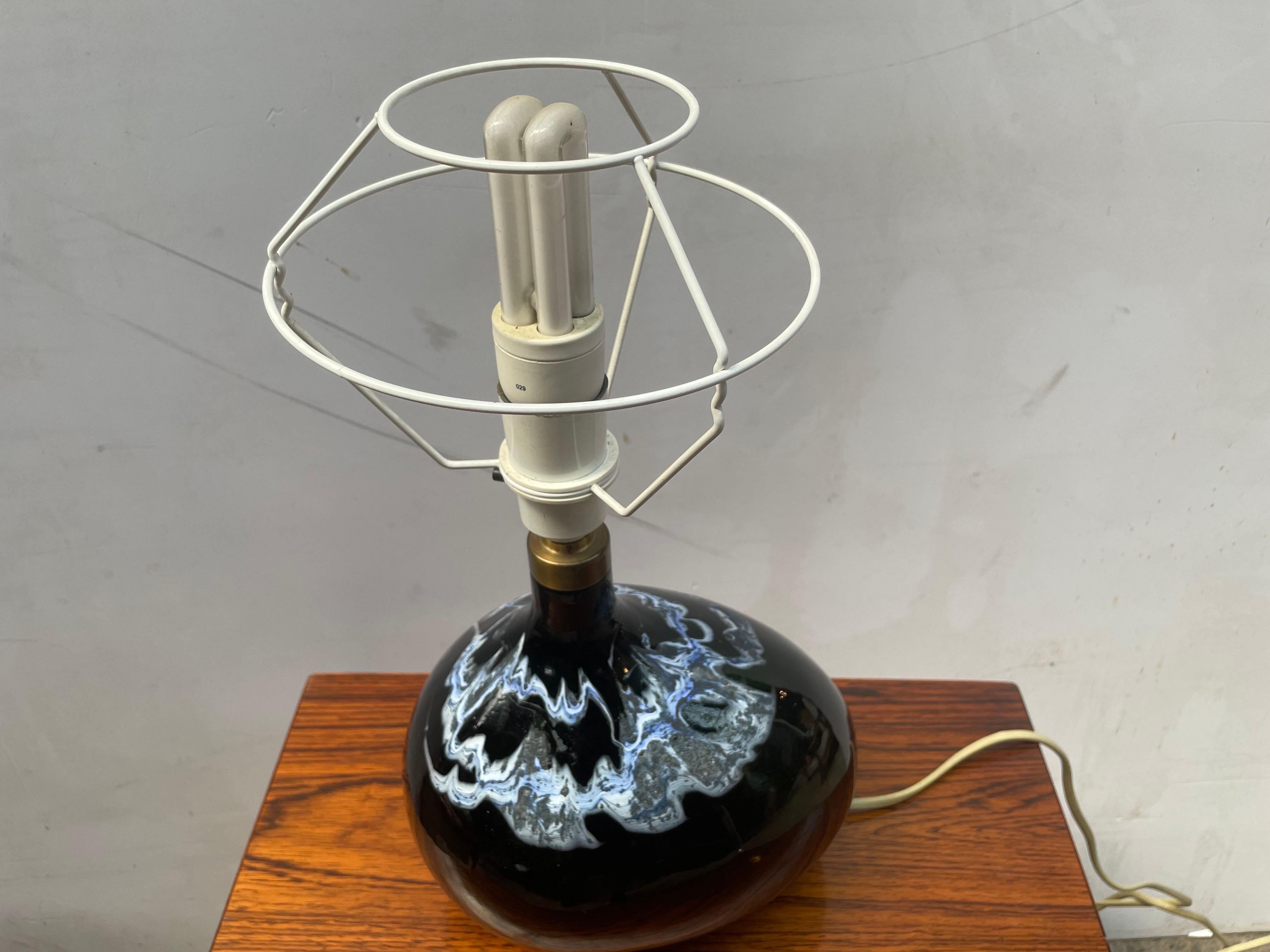Rare Holmegaard Lamp Art Asymmetrical, a stunning piece of design history by Michael Bang, crafted by Holmegaard in Denmark from 1973-1976. This emerald green freeform art glass table lamp features wavy blue and white enamel, each applied by hand,