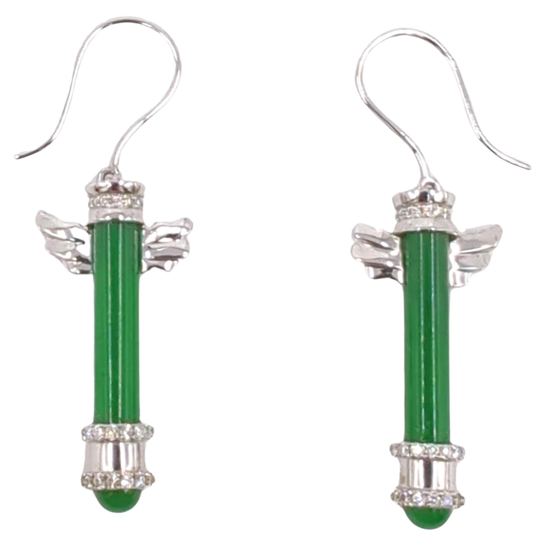 This exceptional pair of earrings is a masterful blend of artistry and luxury, meticulously crafted in white gold and weighing 7.10 grams. The earrings feature four high-quality emerald green jadeite stones—two in pole green and two in cabochon