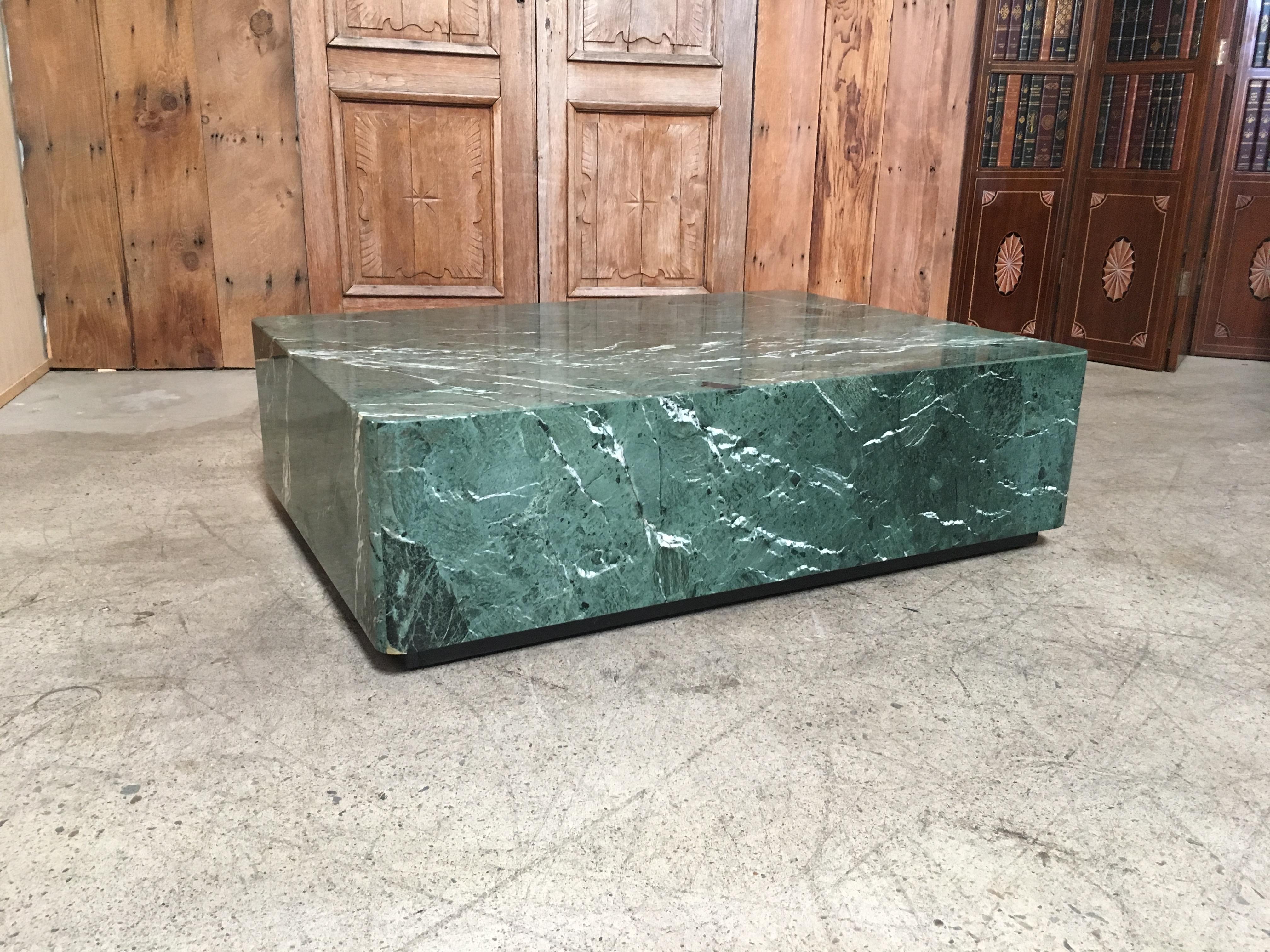 Emerald Green marble modern coffee table with ebonized wood plinth and casters for easy mobility.