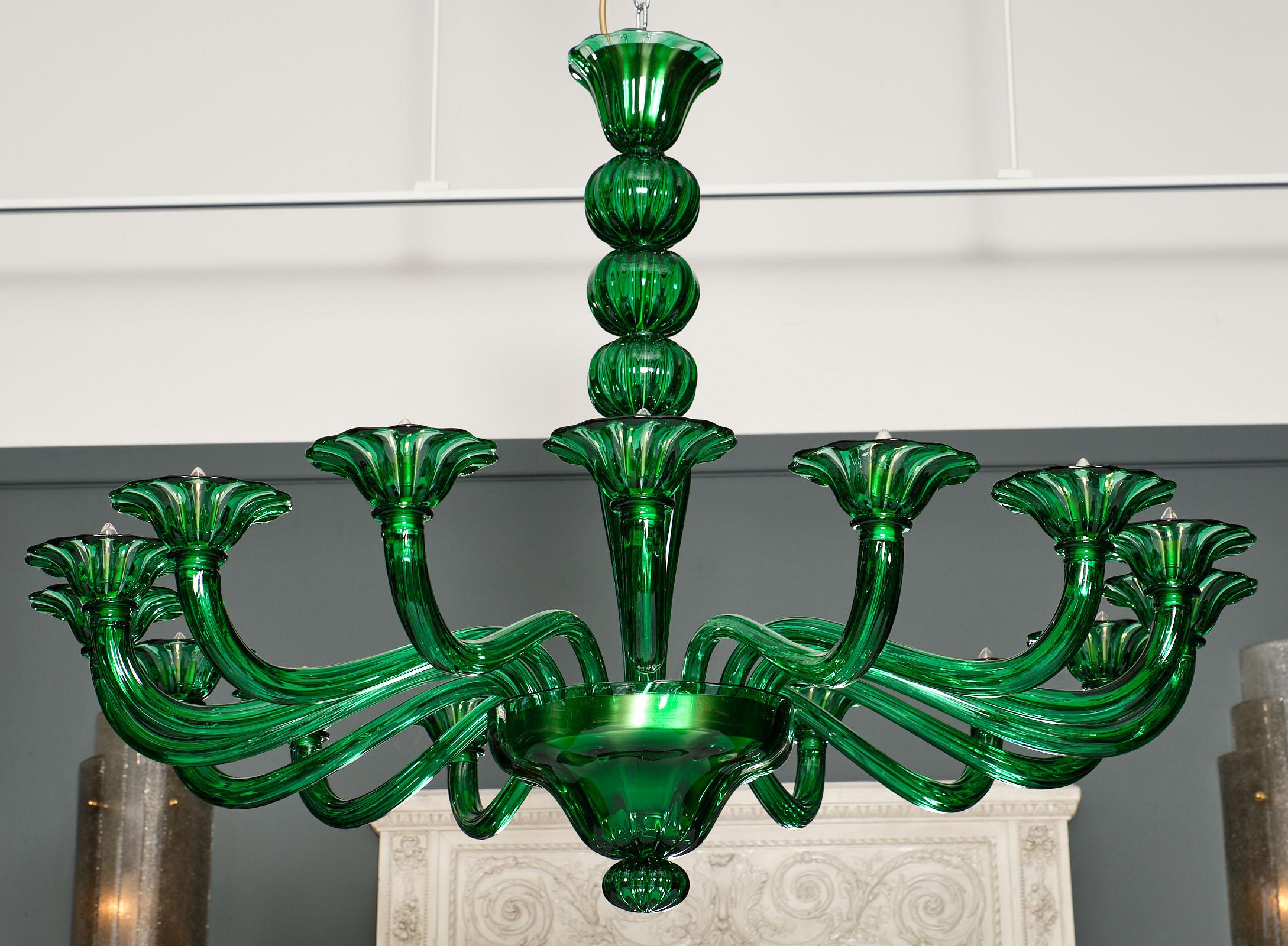 Stunning emerald green Murano glass chandelier made of hand blown glass and featuring 16 arms. This exquisite fixture has an intricate process consisting of two passes with the glass for thickness. Then the piece is heated twice. The ribbing is done