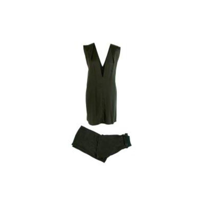 Ann Demeulemeester Emerald green satin top & trousers
 
 - Deep v-neck satin vest top with a crisscross back in an emerald green hue 
 - Matching wide leg trousers with an elasticated waistband buckle fastened belt 
 - Flared cuffs with slight slits