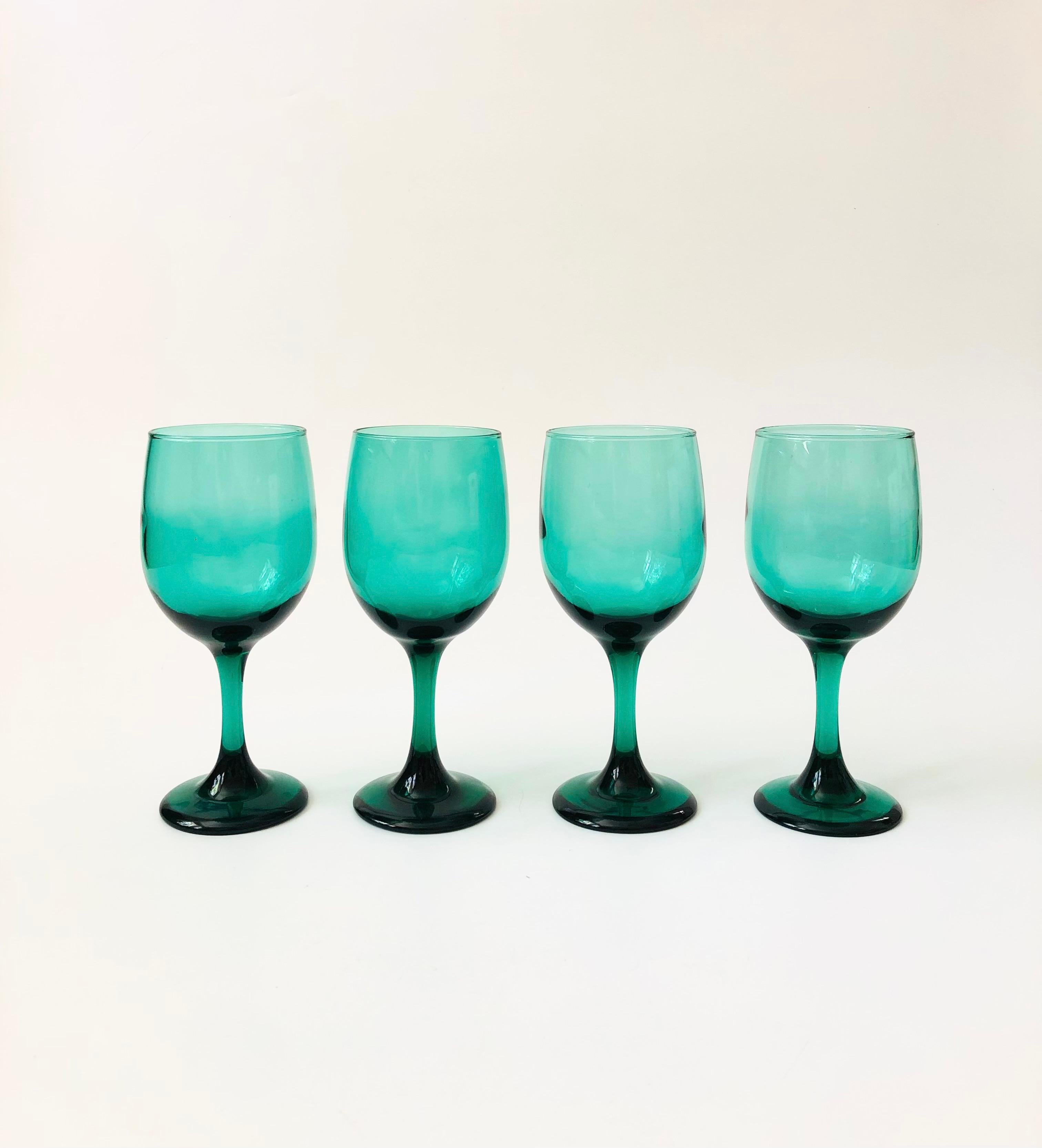 A set of 4 vintage wine glasses. Beautiful moody emerald green color in an elegant tapered shape. 