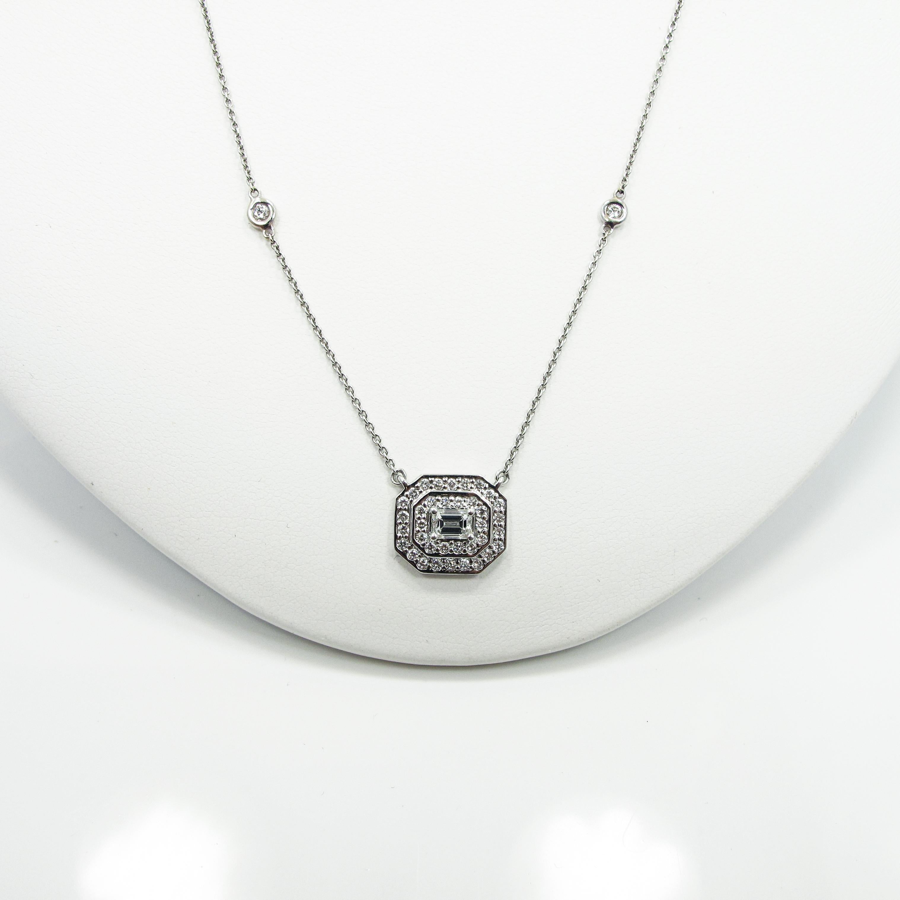 This emerald shape mosaic piece features an emerald cut center diamond (0.34ct F VS1) and is surrounded by a two tier halo with 40 round diamonds (0.35ct approx. F/G VS/SI) set in 14k white gold. The piece is suspended from a 17
