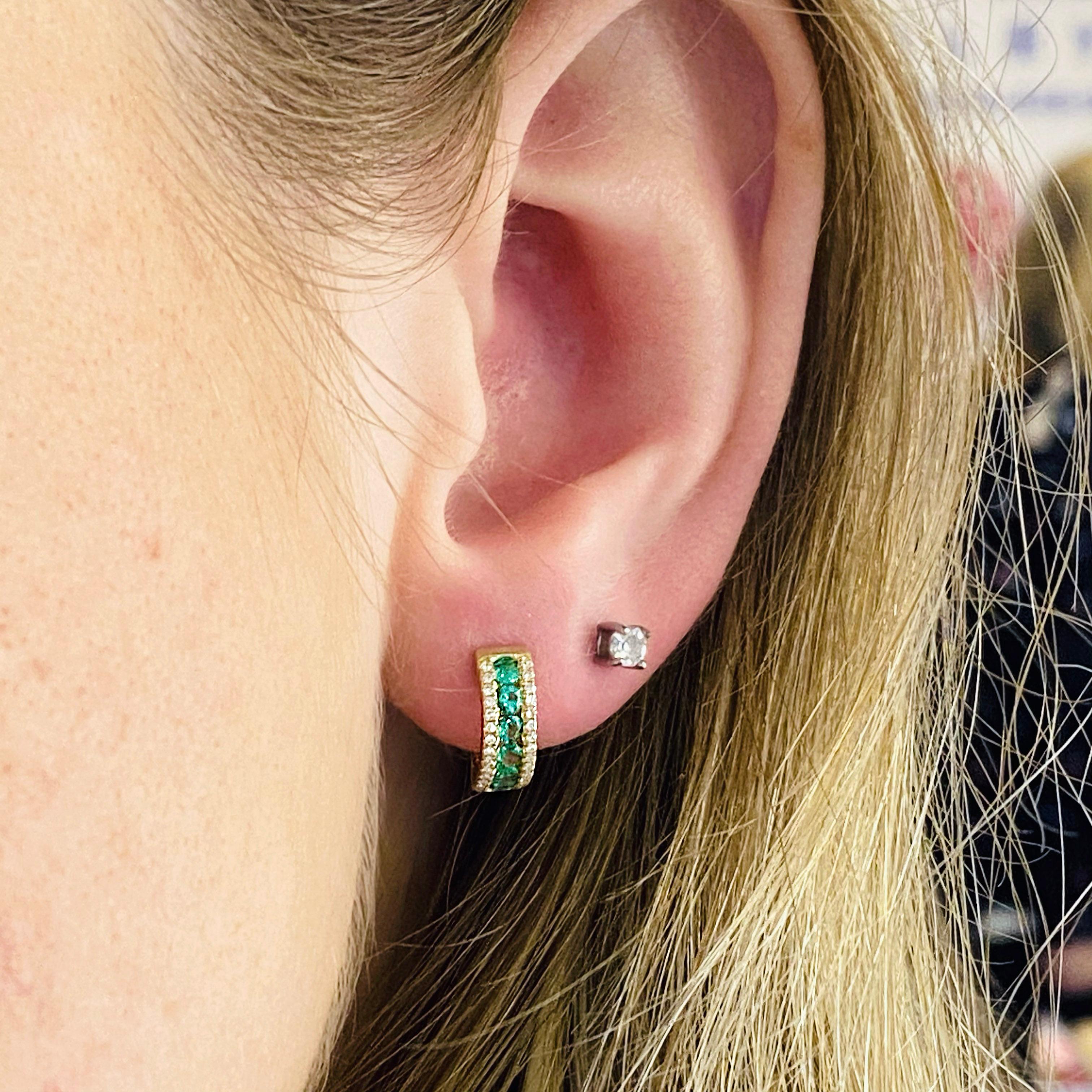 These vibrant green emerald huggie earrings have a diamond edge on either side.  There are 56 diamonds and 12 emeralds.  The emeralds are larger than the diamonds so the color really pops!  The huggie style of the earring has a hinge so that the
