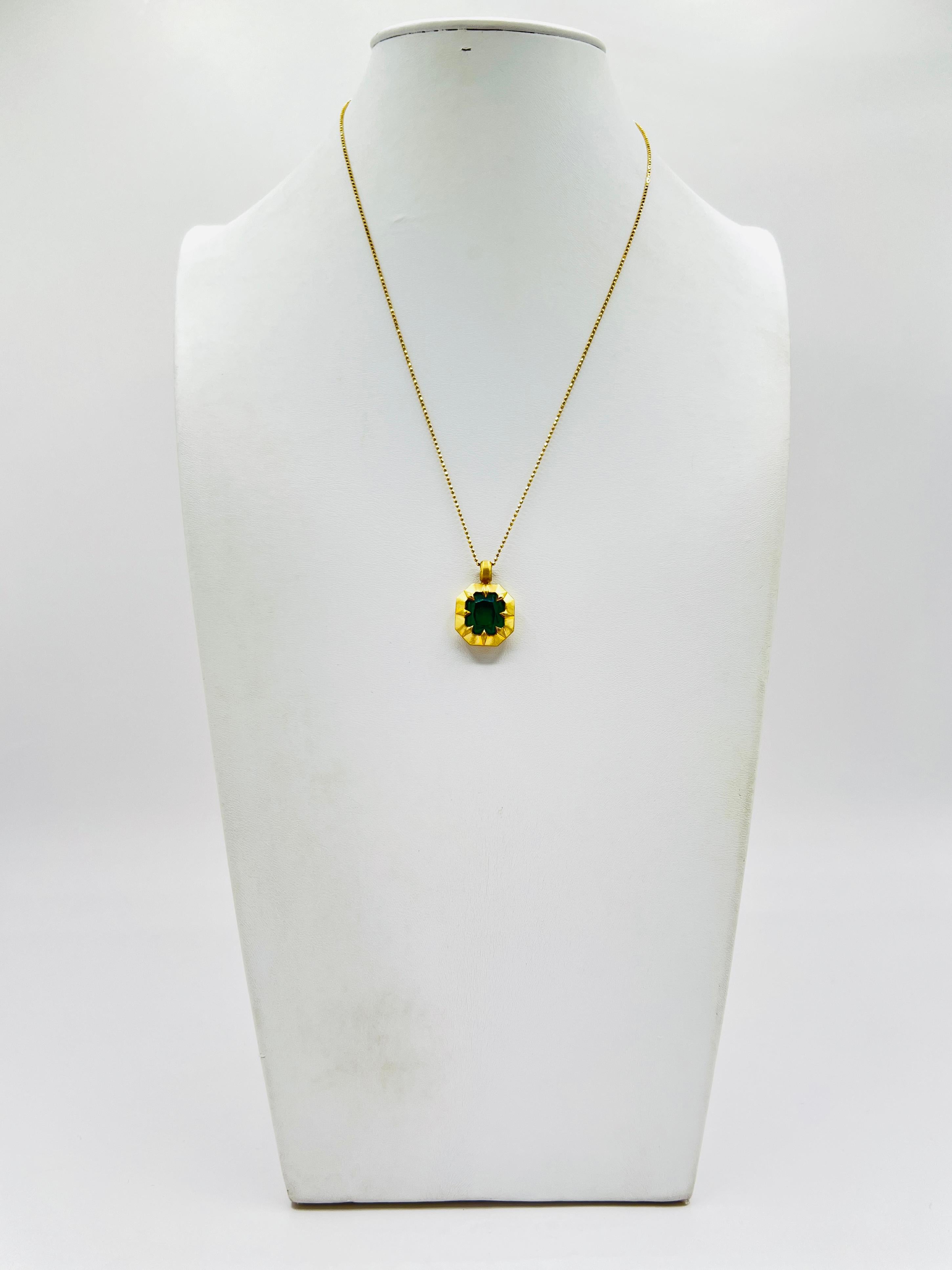 Beautiful 5.90 ct. emerald cut emerald in a satin finish bezel and prong pendant.  Handmade in 18k yellow gold.  Length of chain is 18