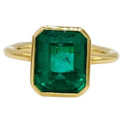 Emerald in Emerald Cut Bezel Solitaire Ring in 18K Yellow Gold
