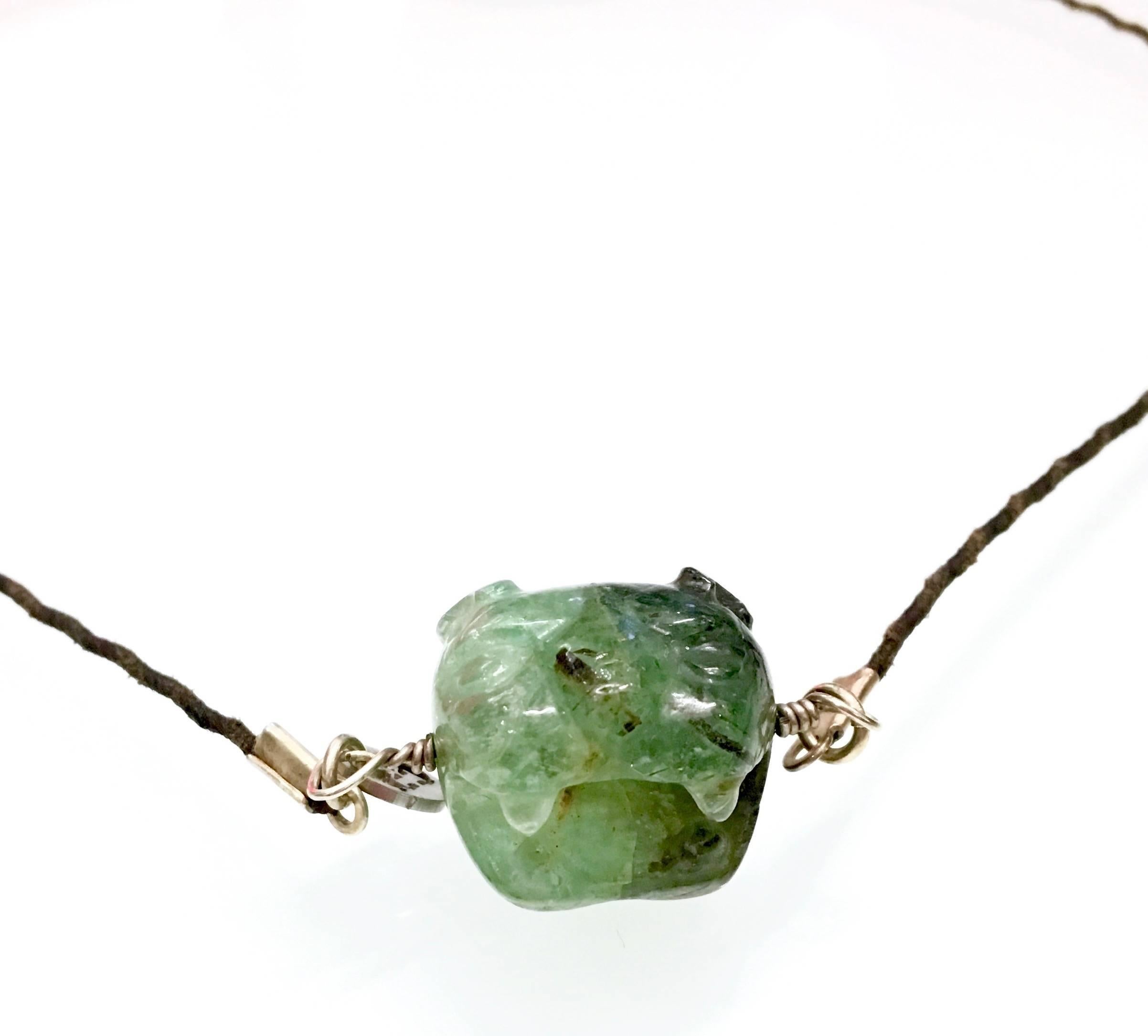 Magnificent colombian emerald hand carved in the form of a jaguar.