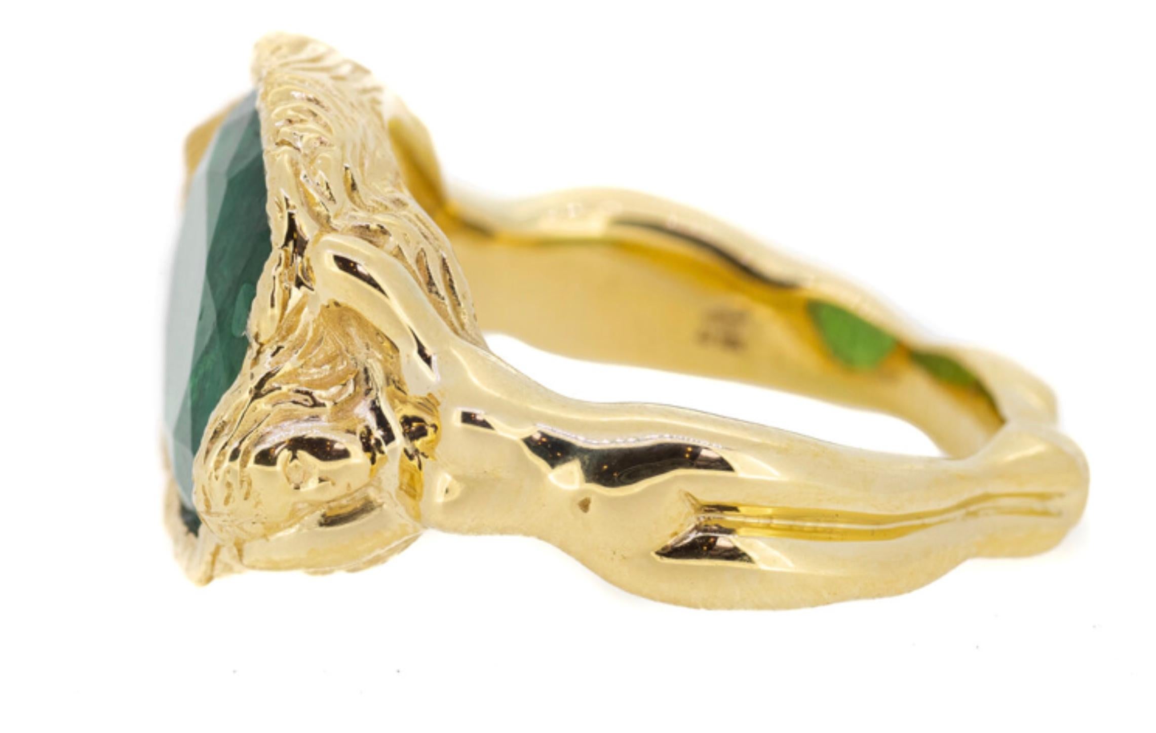 The Emerald Maiden Ring is a symbolic and sculptural design cast in 18K yellow gold. Two female forms intertwine to form the band, their graceful bodies supporting a vivid 6.33-carat emerald at the centre. The emerald, a stone long associated with