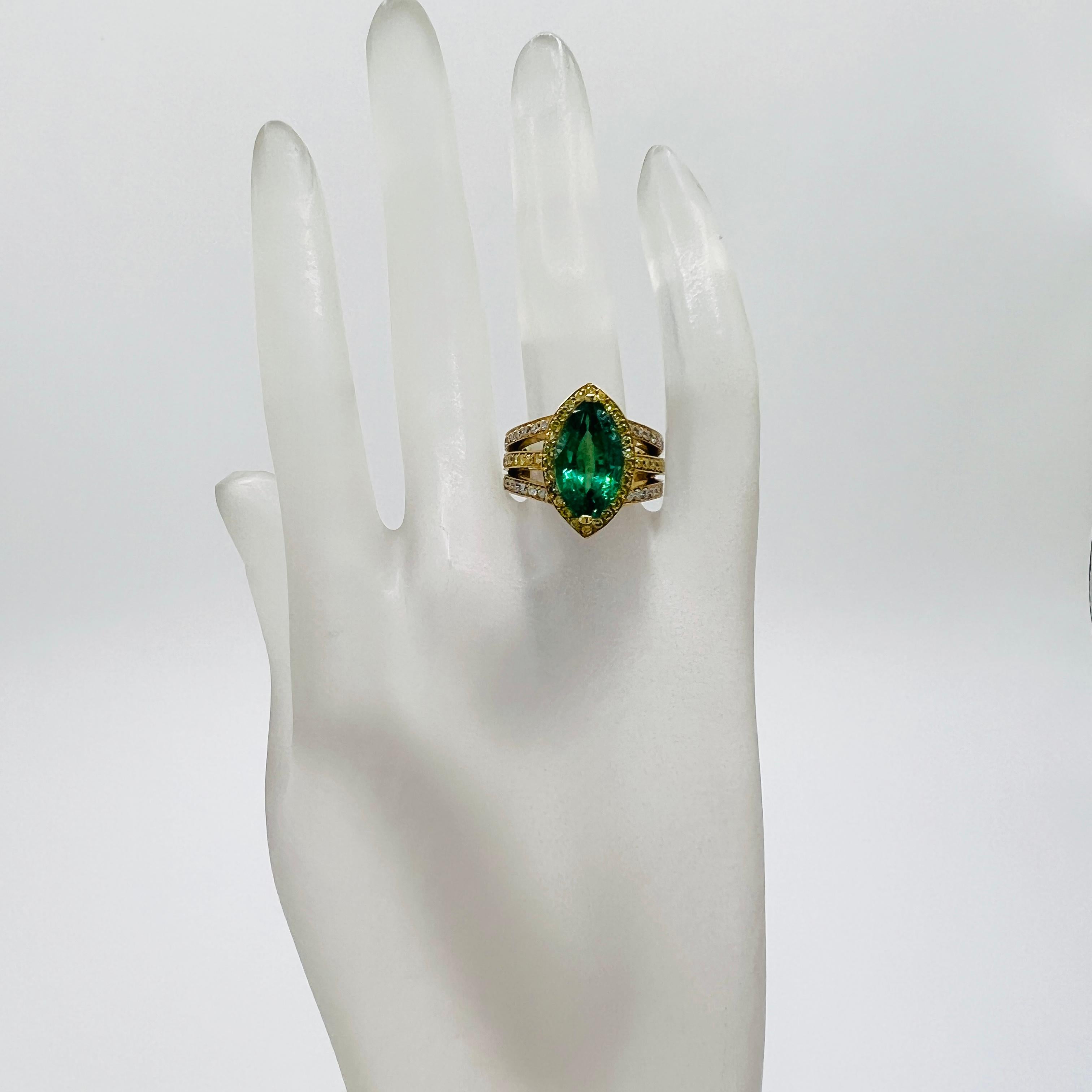 Beautiful 5.00 ct. emerald marquise with good quality white and yellow diamond rounds.  Handmade in 18k yellow gold.  Ring size 7.