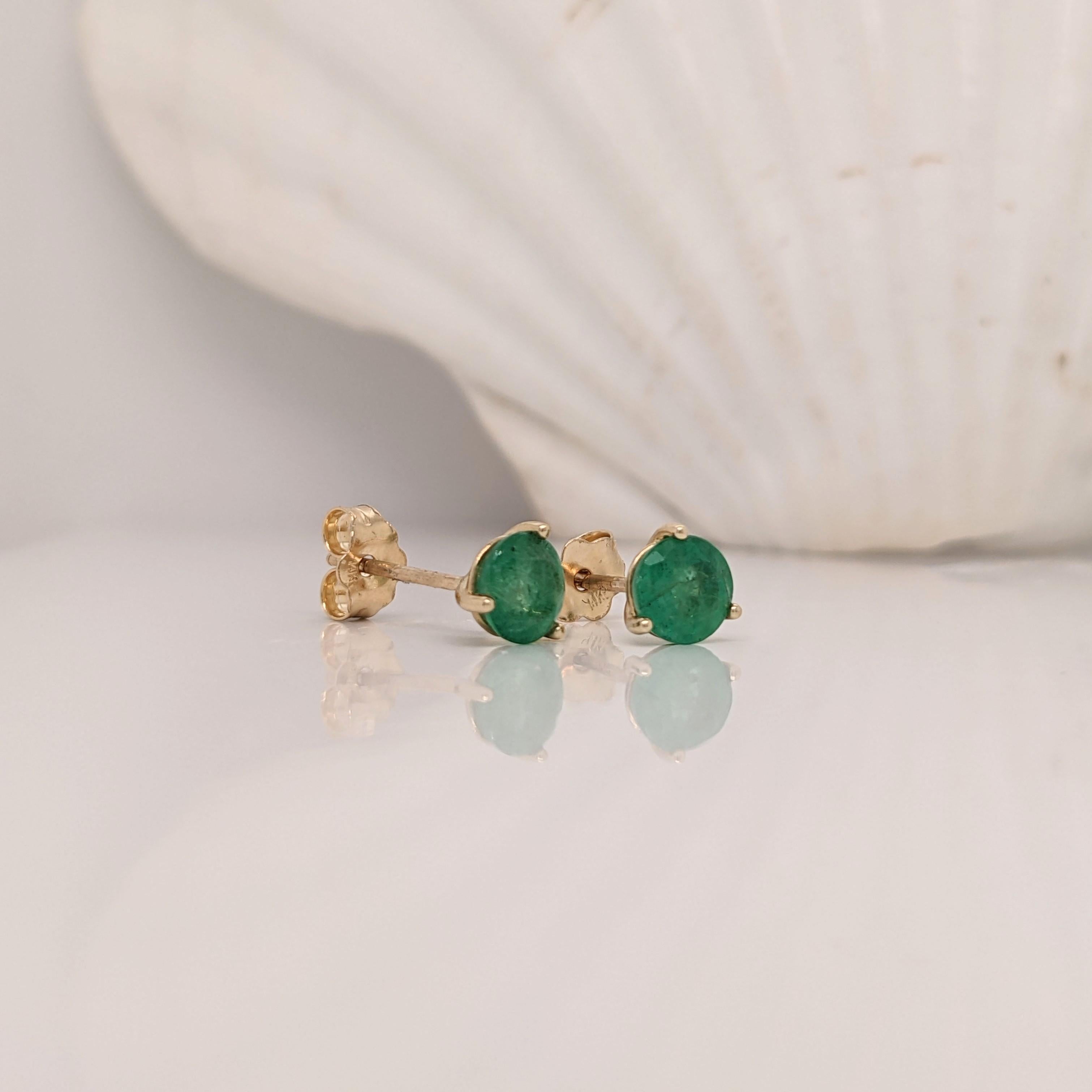 Elegant emerald round solitaire studs in solid 14K gold. The vibrant green emeralds are beautifully set in these stud earrings. A secure push back closure ensures comfortable wear throughout the day. These earrings make a stunning May birthstone