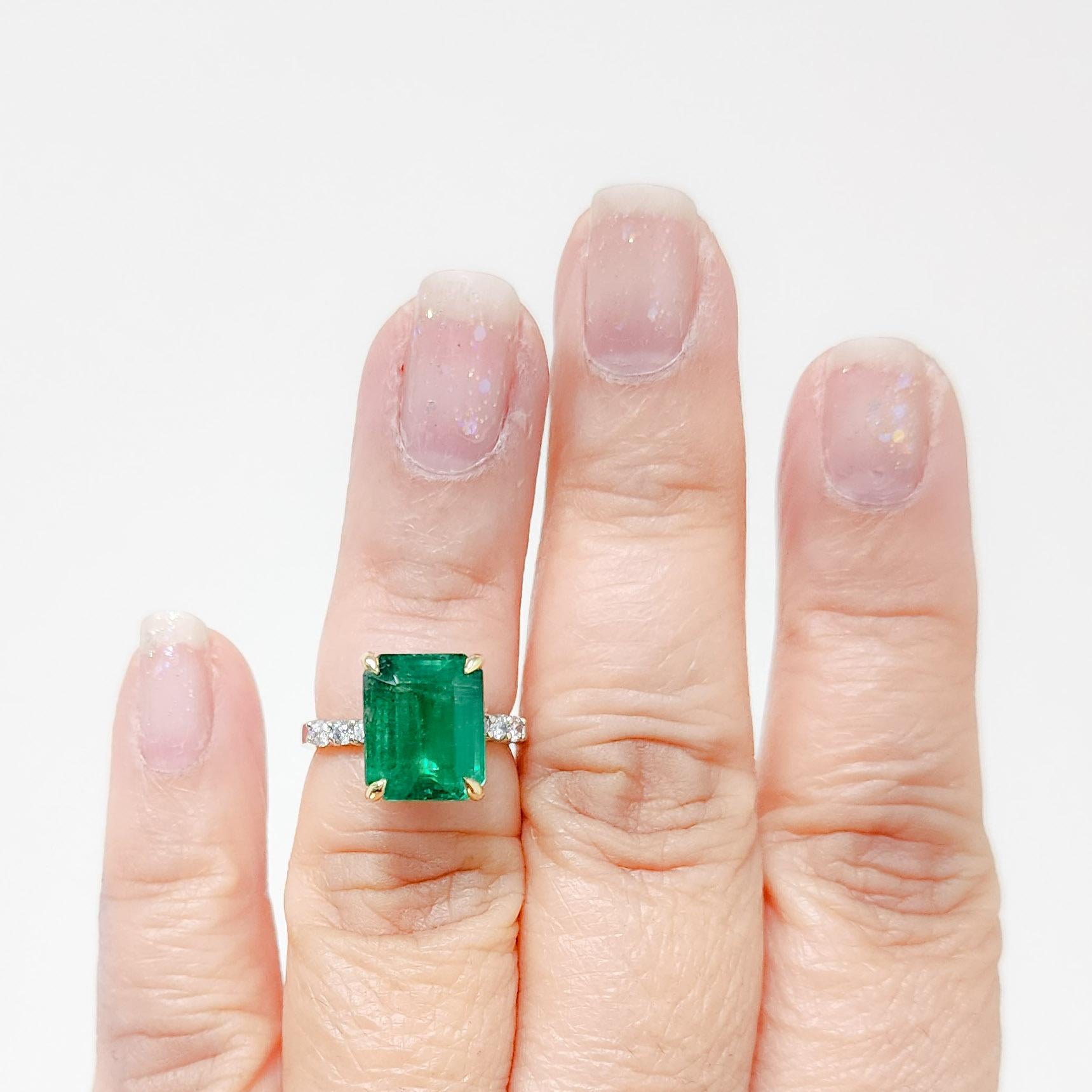 Beautiful 5.78 ct. emerald emerald cut with good quality white diamond rounds.  Handmade in 14k yellow and white gold.  Ring size 5.