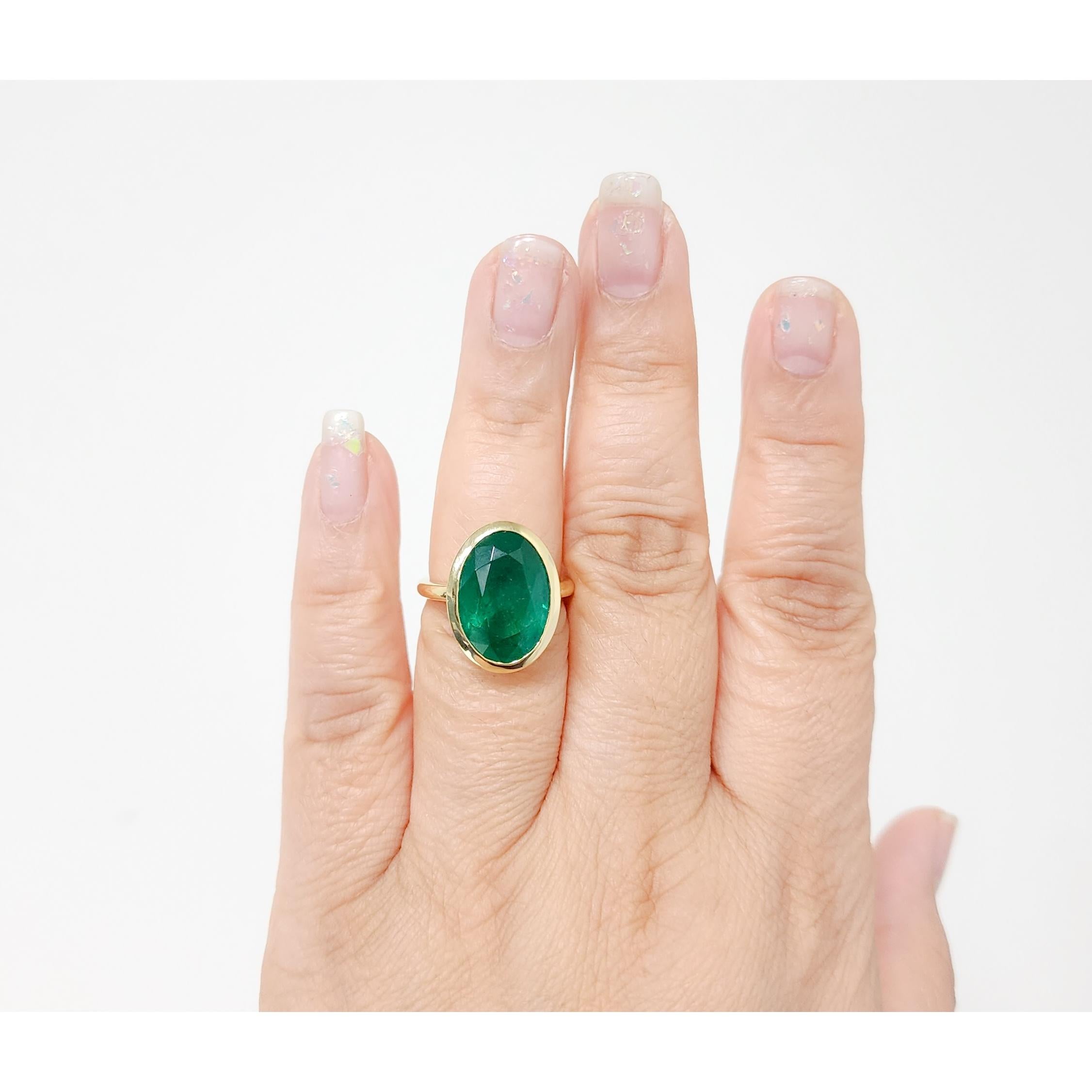 Beautiful 10.97 ct. emerald oval in a handmade 18k yellow gold bezel ring.  Ring size 7.