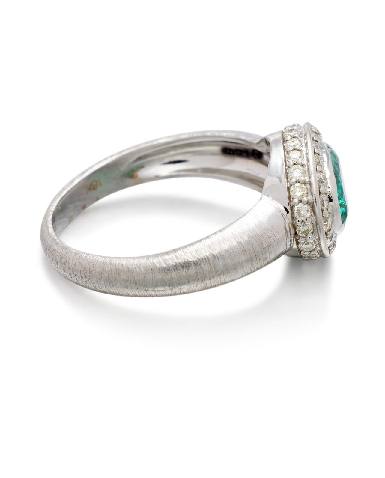 Contemporary Emerald oval and Diamond Engagement Ring In 18K White Gold.  For Sale
