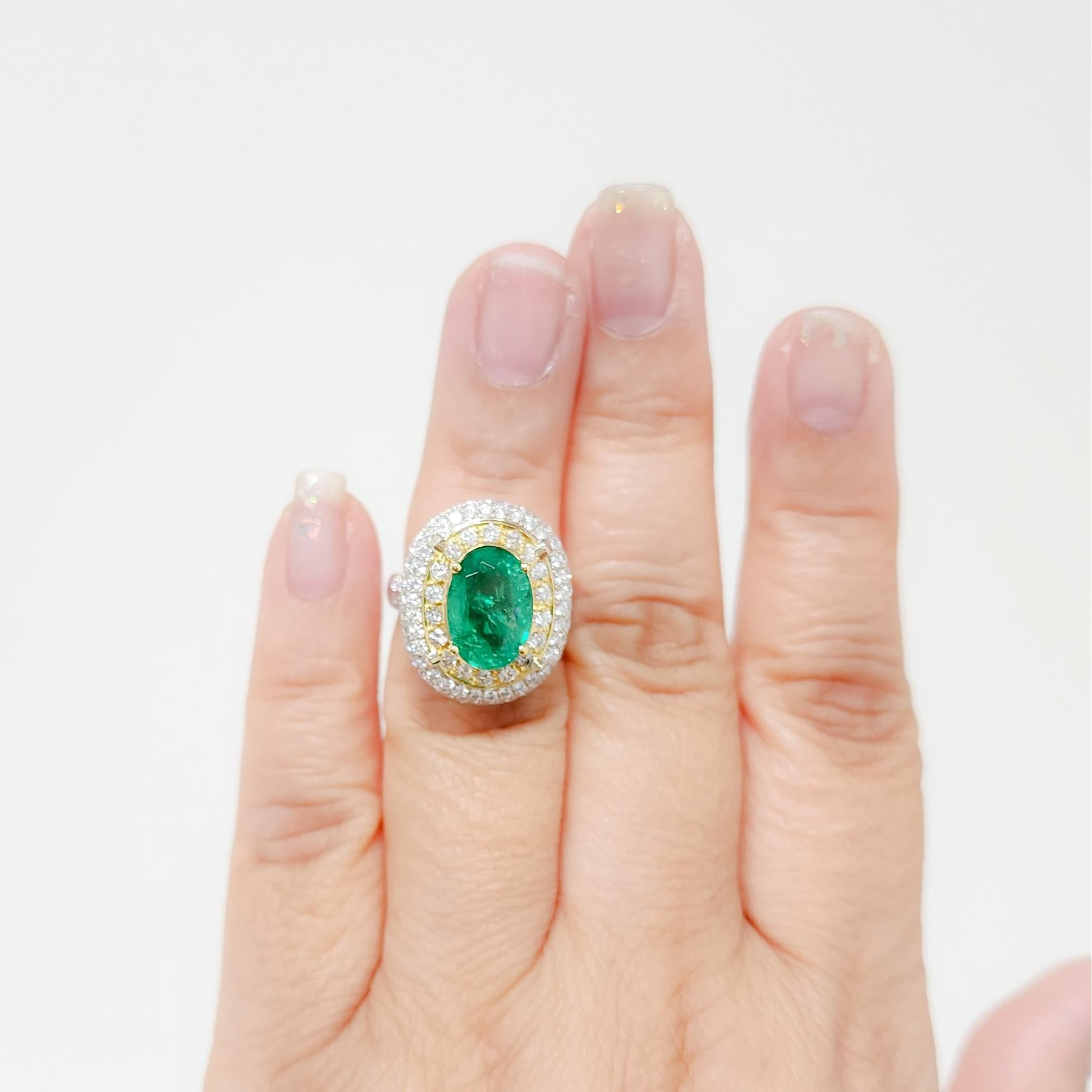 Beautiful 4.06 ct. emerald oval with 1.31 ct. good quality, white, and bright diamond rounds.  Handmade in 14k white and yellow gold.  Ring size 5.75.