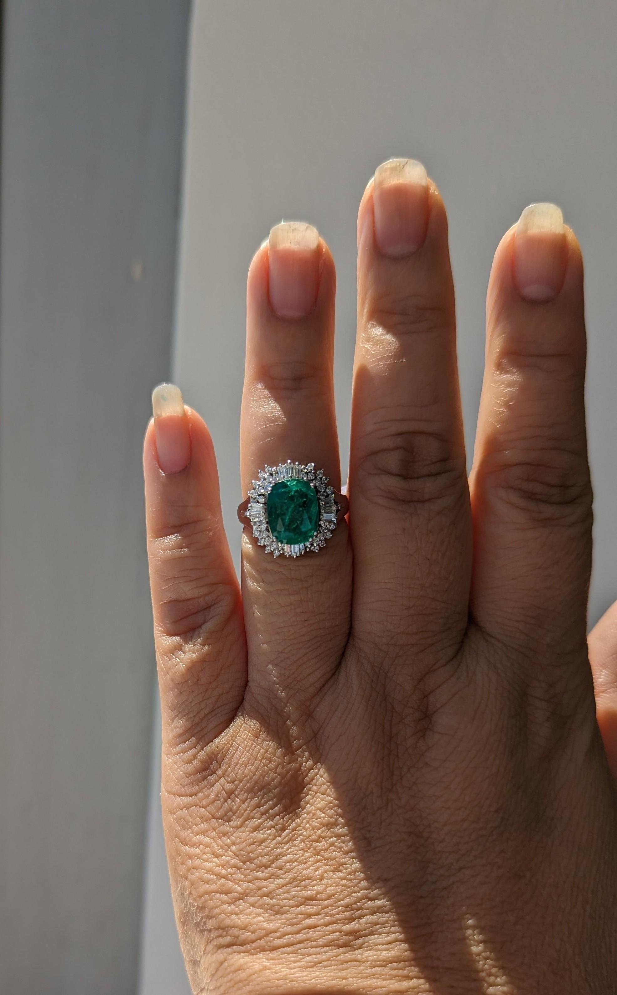 Beautiful 3.64 ct. emerald oval with good quality white diamond baguettes and rounds.  Handmade in platinum.  Ring size 7.