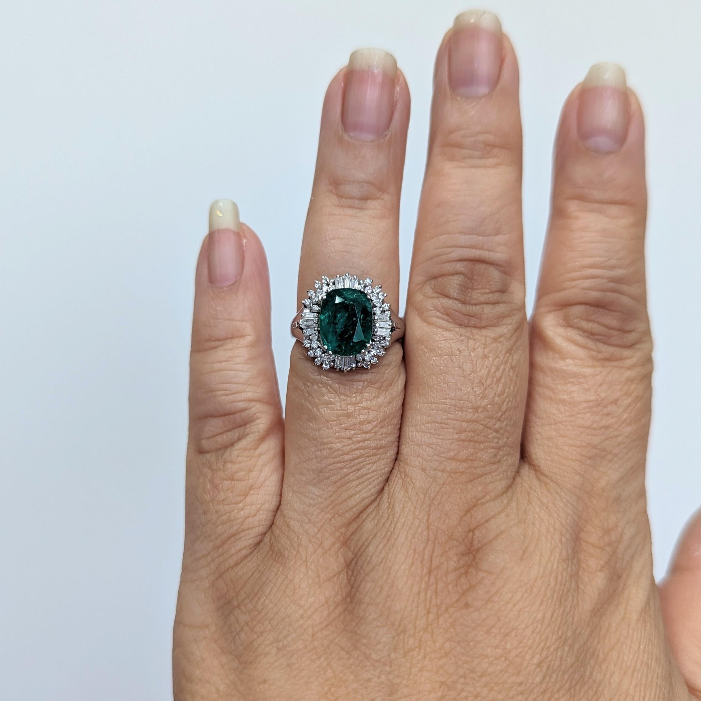 Oval Cut Emerald Oval and White Diamond Cluster Ring in Platinum For Sale