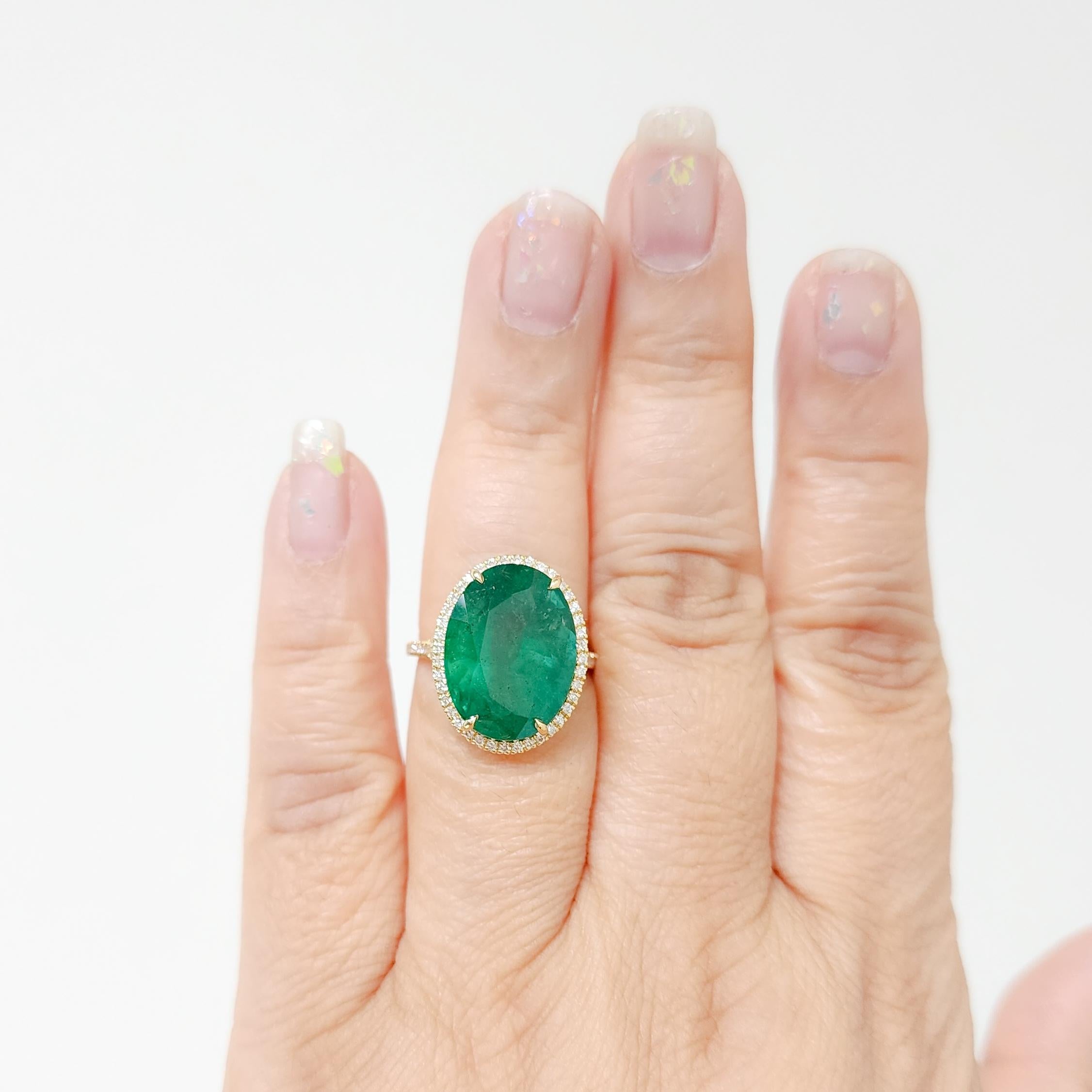 Stunning 11.74 ct. emerald oval with 0.67 ct. good quality white diamond rounds.  Handmade in 18k yellow gold.  Ring size 6.25.