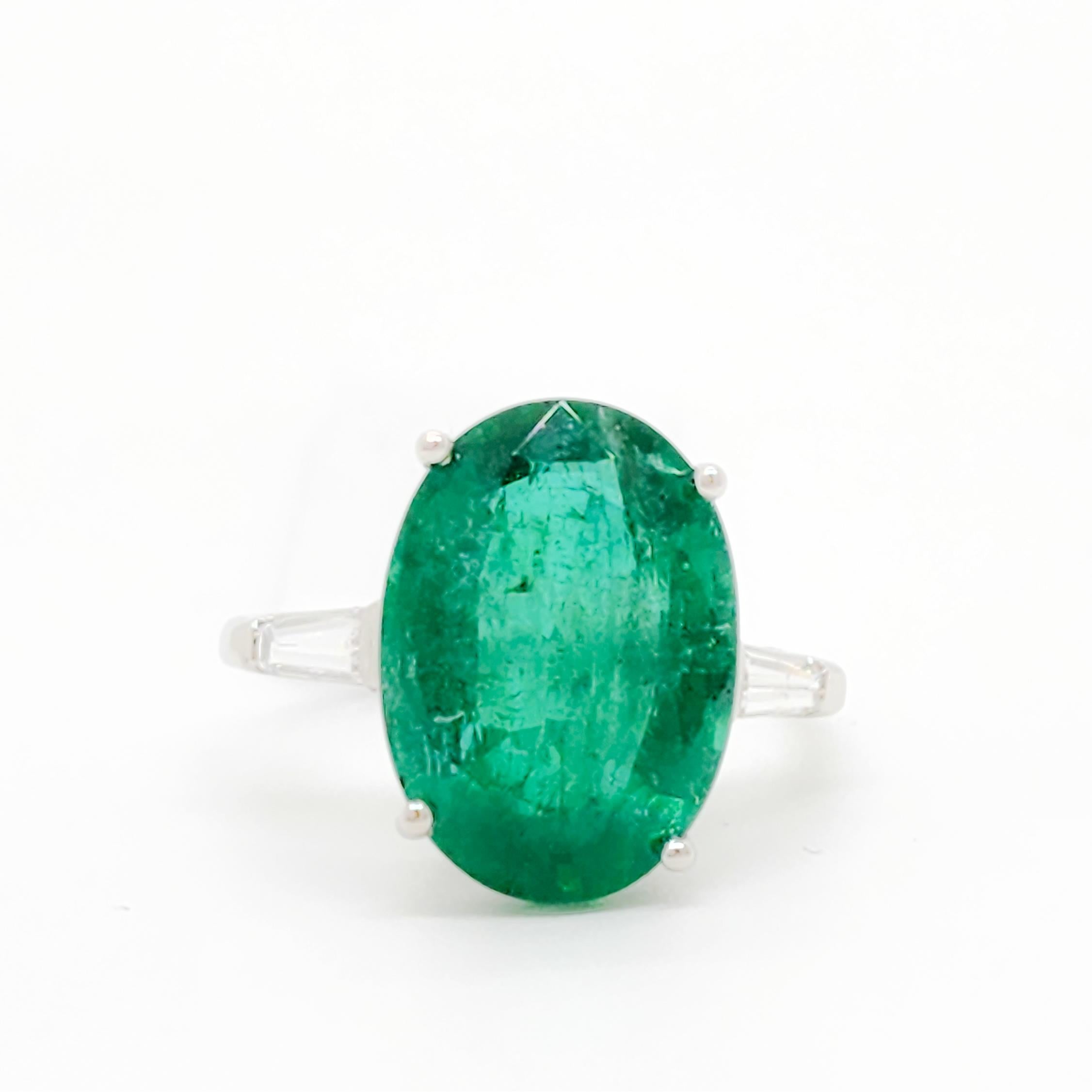 Gorgeous 8.99 ct. emerald oval with good quality white diamond baguettes.  Handmade in platinum.  Ring size 9.5.
