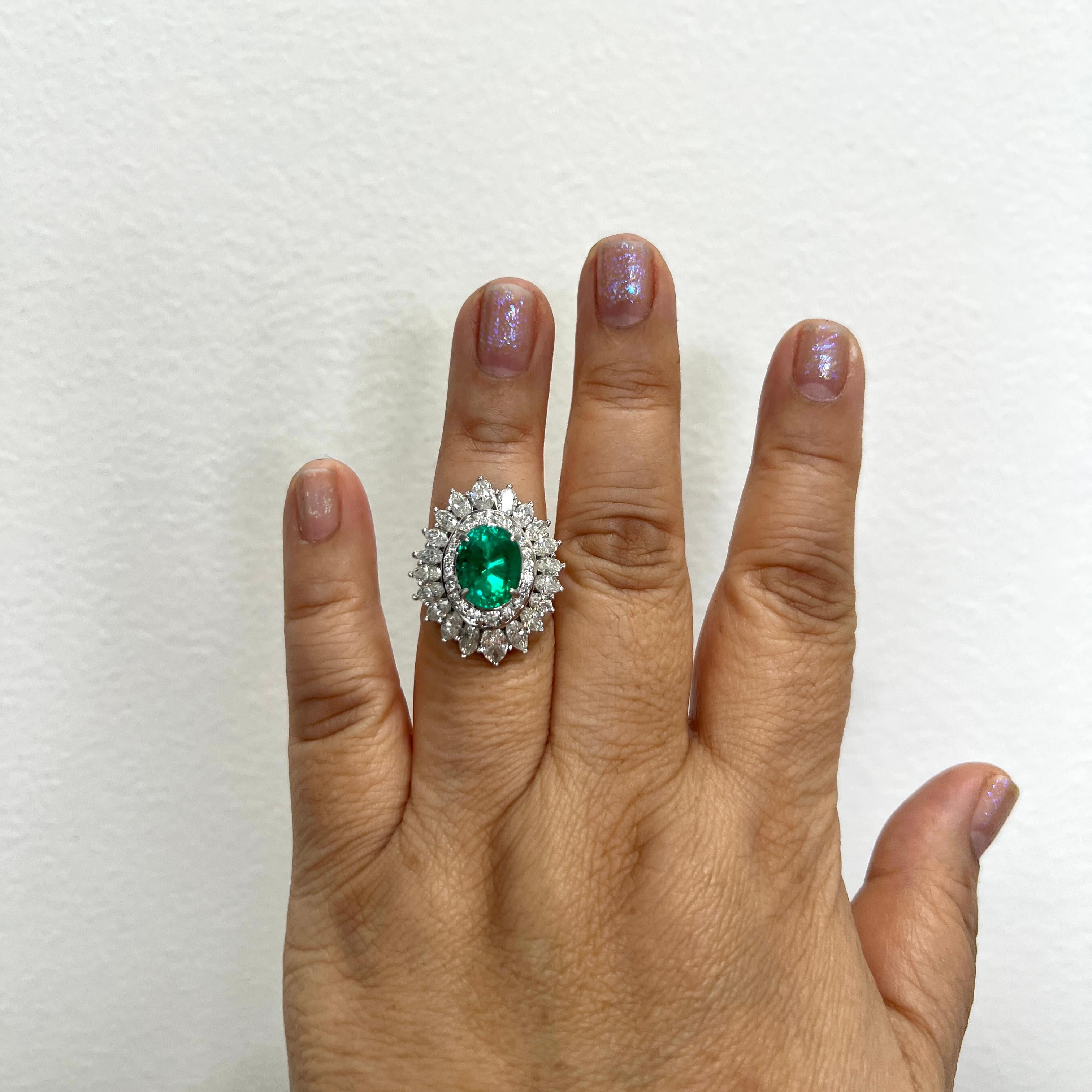 Beautiful 3.83 ct. Colombian emerald oval with 3.98 ct. good quality white diamond marquise and rounds.  Handmade in platinum.  Ring size 6.25.