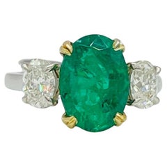 Emerald Oval and White Diamond Oval Three Stone Ring in Platinum & 18K Gold